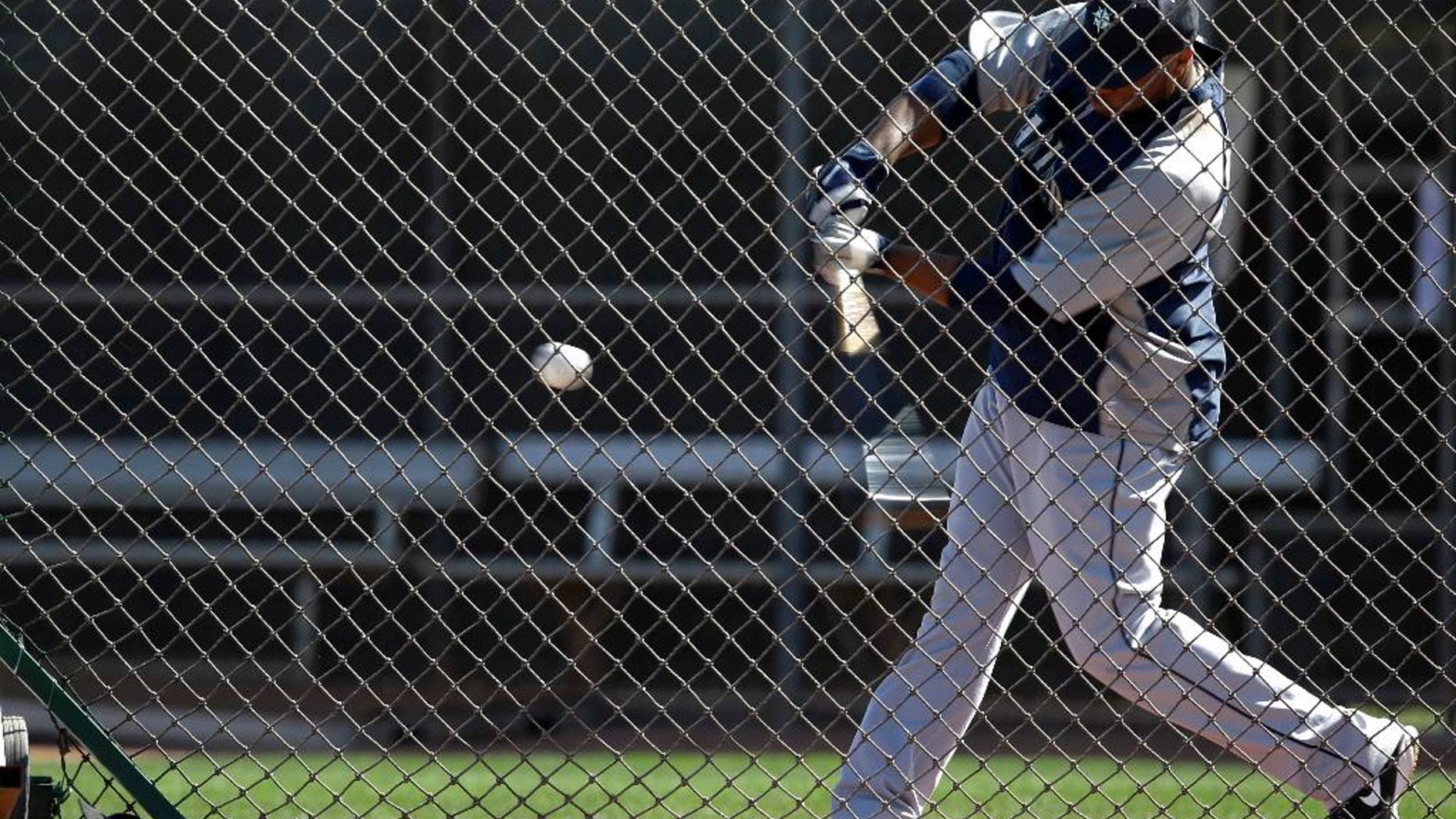 Seattle Mariners' Robinson Cano takes a swing as he participates in batting drills during baseball spring training, Wednesday, Feb. 26, 2014, in Peoria, Ariz. (AP Photo/Tony Gutierrez)