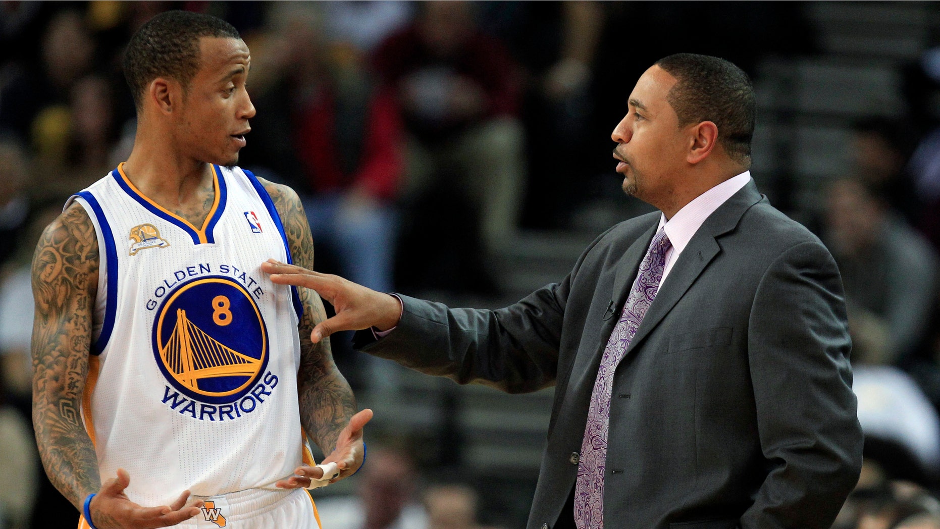Golden State Warriors coach Mark Jackson talks to Monta Ellis as the Warriors played the Orlando Magic during the first half of an NBA basketball game in Oakland, Calif., Thursday, Jan. 12, 2012. (AP Photo/Marcio Jose Sanchez)