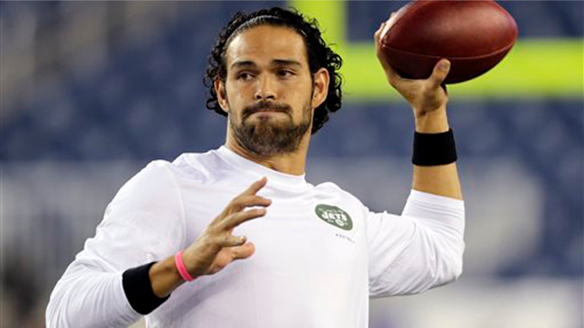 FILE - In a Sept. 12, 2013 filel photo, New York Jets quarterback Mark Sanchez, who normally throws right-handed, throws a pass with his left hang before an NFL football between the New England Patriots and the Jets game, in Foxborough. The New York Jets released Sanchez signed quarterback Michael Vick on Friday, March 21, 2014. Sanchez spent this past season on injured reserve after injuring his right shoulder in a preseason game. (AP Photo/Charles Krupa, File)
