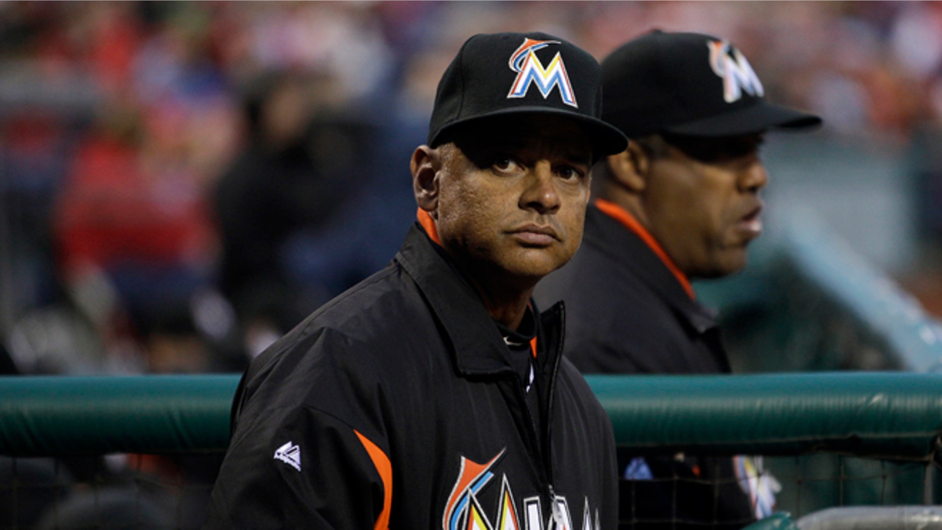 Miami Marlins bench coach Joey Cora watches a baseball game against the Philadelphia Phillies, Wednesday, April 11, 2012, in Philadelphia.