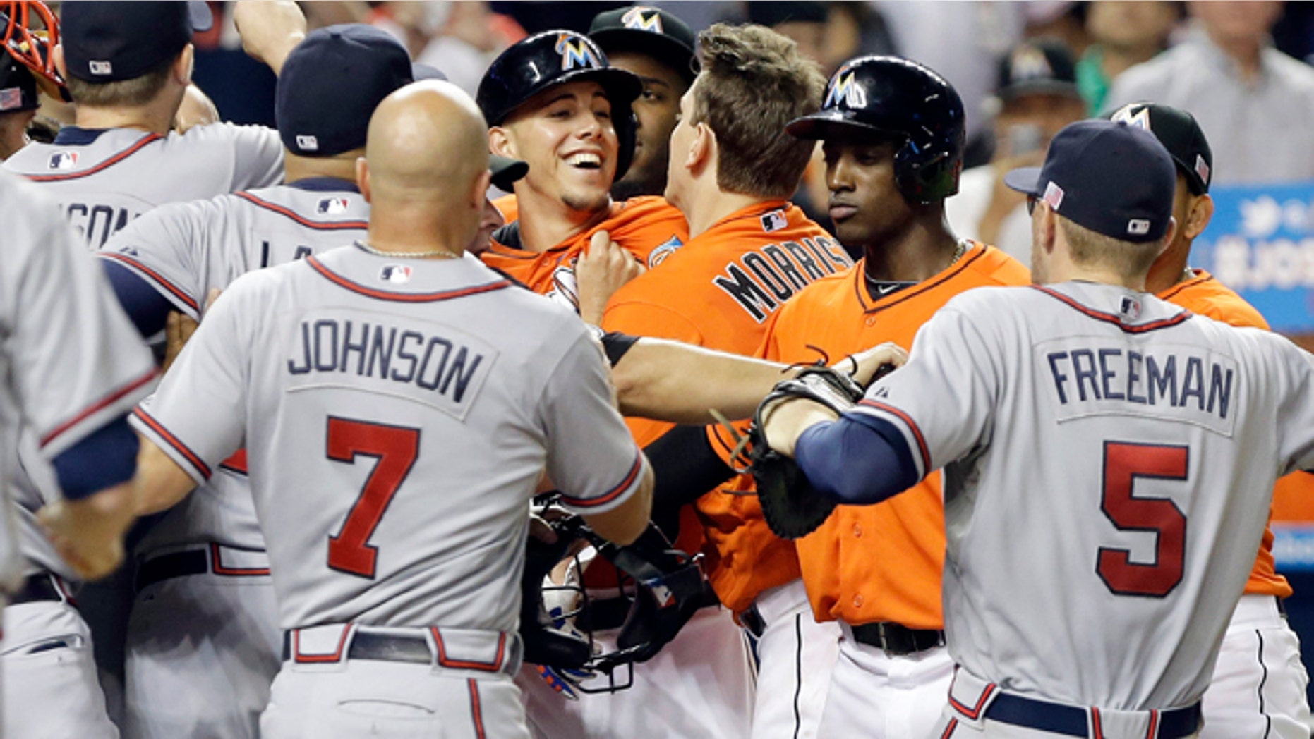Miami Marlins starting pitcher Jose Fernandez is surrounded by Atlanta Braves players after an altercation broke out Wednesday, Sept. 11, 2013, in Miami.