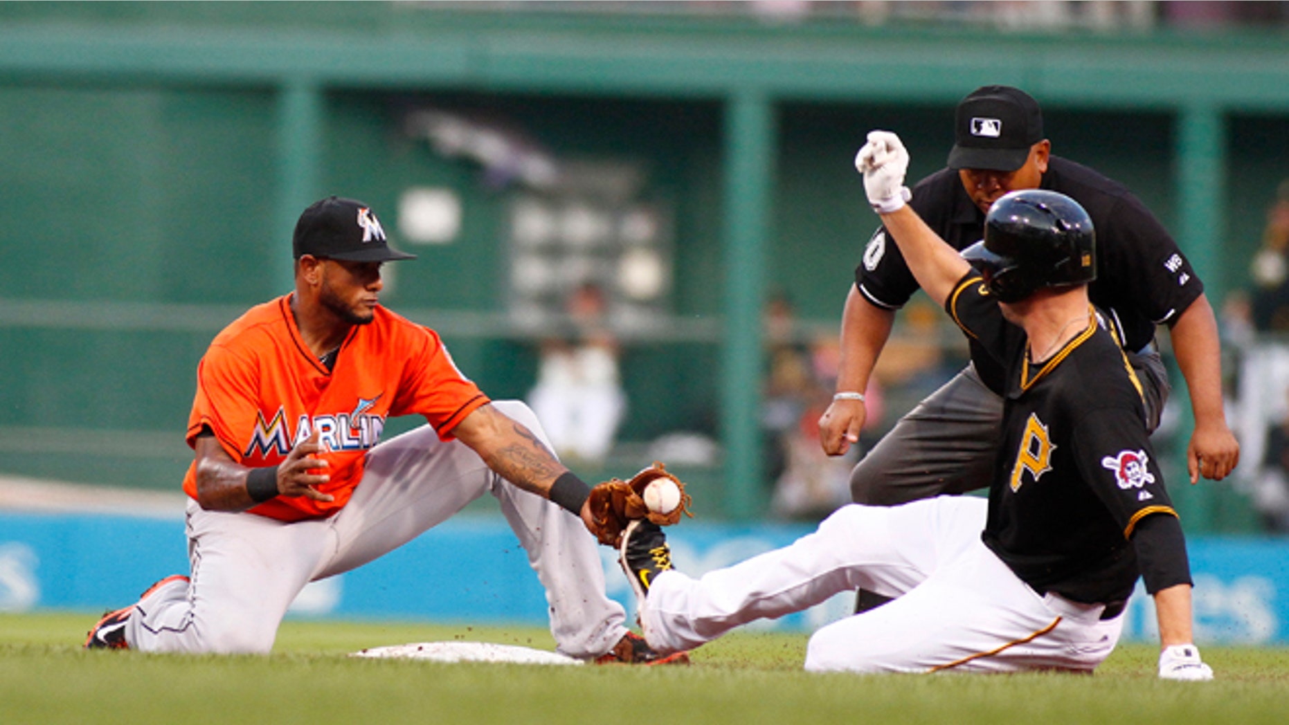 PITTSBURGH, PA - AUGUST 07: Jordy Mercer #10 of the Pittsburgh Pirates slides in safe against Jordany Valdespin #1 of the Miami Marlins during the game at PNC Park on August 7, 2014 in Pittsburgh, Pennsylvania. (Photo by Justin K. Aller/Getty Images)