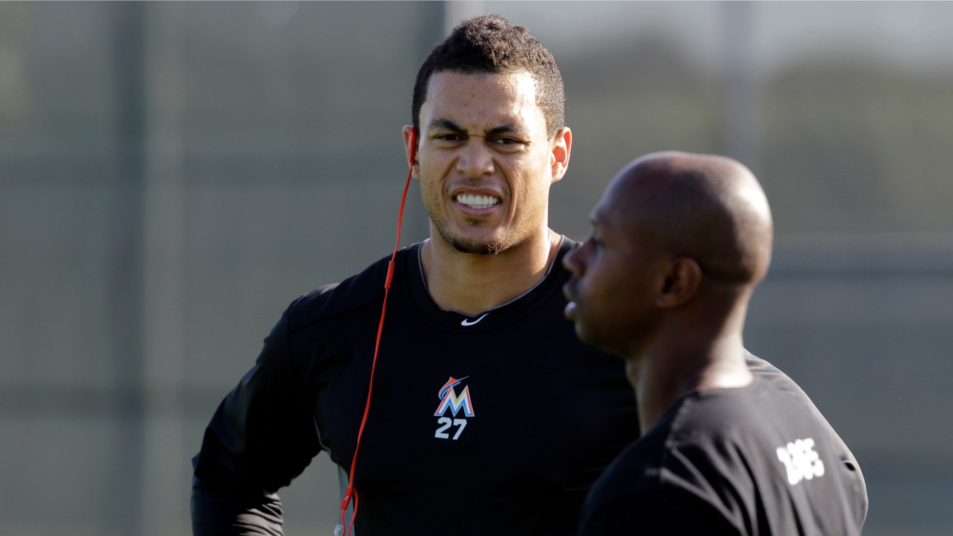 Miami Marlins outfielders Giancarlo Stanton, left, and Juan Pierre talk on a practice field in Jupiter, Fla., Feb. 12, 2013.