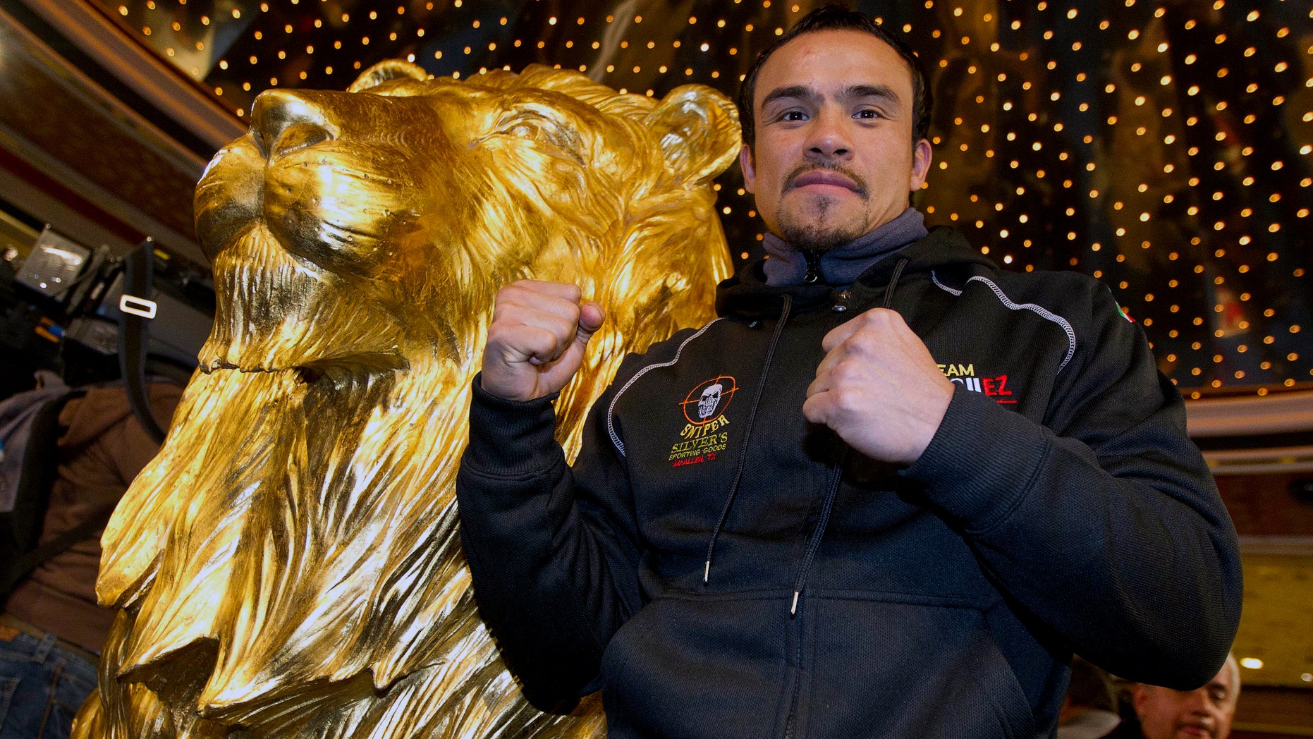 Juan Manuel Marquez poses for photographers upon arriving at the MGM Grand Hotel and Casino, Monday, Nov. 7, 2011, in Las Vegas. Juan Manuel Marquez will face Manny Pacquiao for the world welterweight championship on Saturday. (AP Photo/Julie Jacobson)