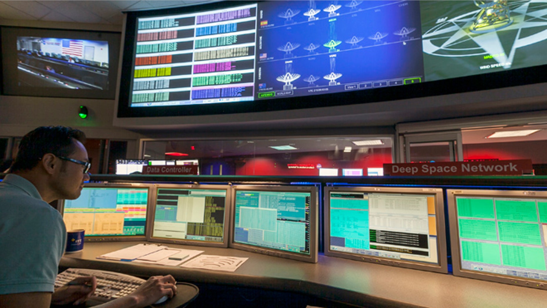 Aug. 2, 2012: This file photo shows Nick Lam, data controller, monitoring the Mars rover Curiosity from the Deep Space Network's control room at NASA's Jet Propulsion Laboratory in Pasadena, Calif.
