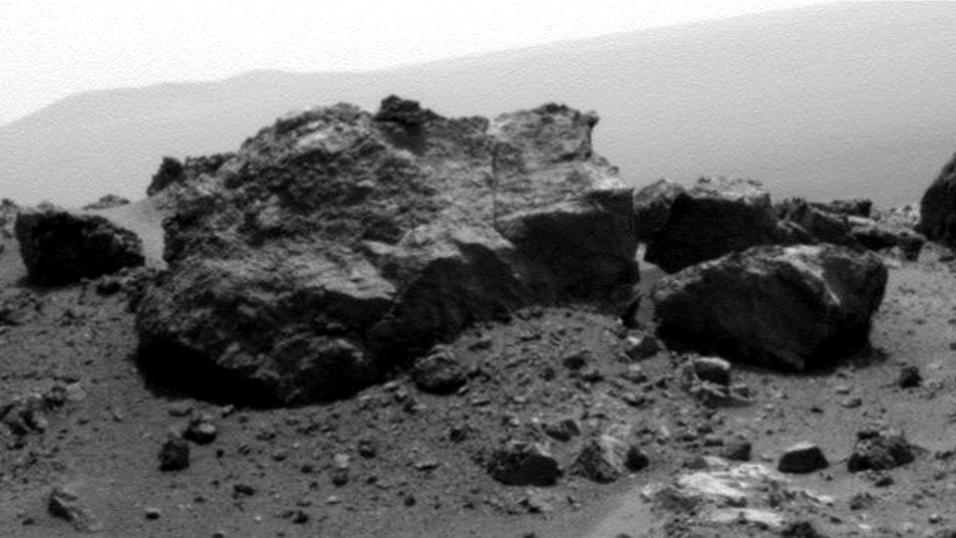 Aug. 13, 2011: NASA's Mars Exploration Rover Opportunity looked across a small crater on the rim of a much larger crater to capture this raw image from its panoramic camera during the rover's 2,685th Martian day, or sol, of work on Mars.