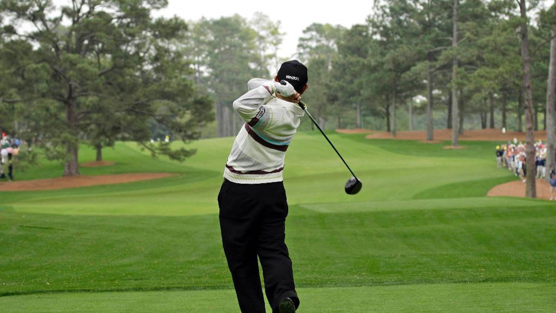 ADVANCE FOR WEEKEND EDITIONS, APRIL 4-5 - FILE - In this April 8, 2008, file photo, Toru Taniguchi of Japan tees off on the 17th hole of the Augusta National Golf Club, with the Eisenhower Tree at left, during practice for the 2008 Masters golf tournament in Augusta, Ga. Most players walking up the hill toward the 17th fairway at Augusta National can't help but notice the famous Eisenhower Tree _ a loblolly pine, far enough from the tee to be a nuisance, sprawling at 65 feet and getting taller by the year. It was about the only feature that gave definition to perhaps the dullest hole on the back nine of the Masters. The tree was lost to an ice storm. Except for the historical significance, hardly anyone will miss it. (AP Photo/David J. Phillip, File)