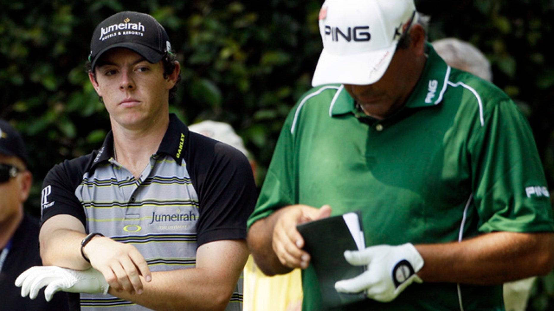 April 10, 2011: Rory McIlroy, left, of Northern Ireland looks over at Angel Cabrera of Argentina as he checks his course notes during the final round of the Masters golf tournament.
