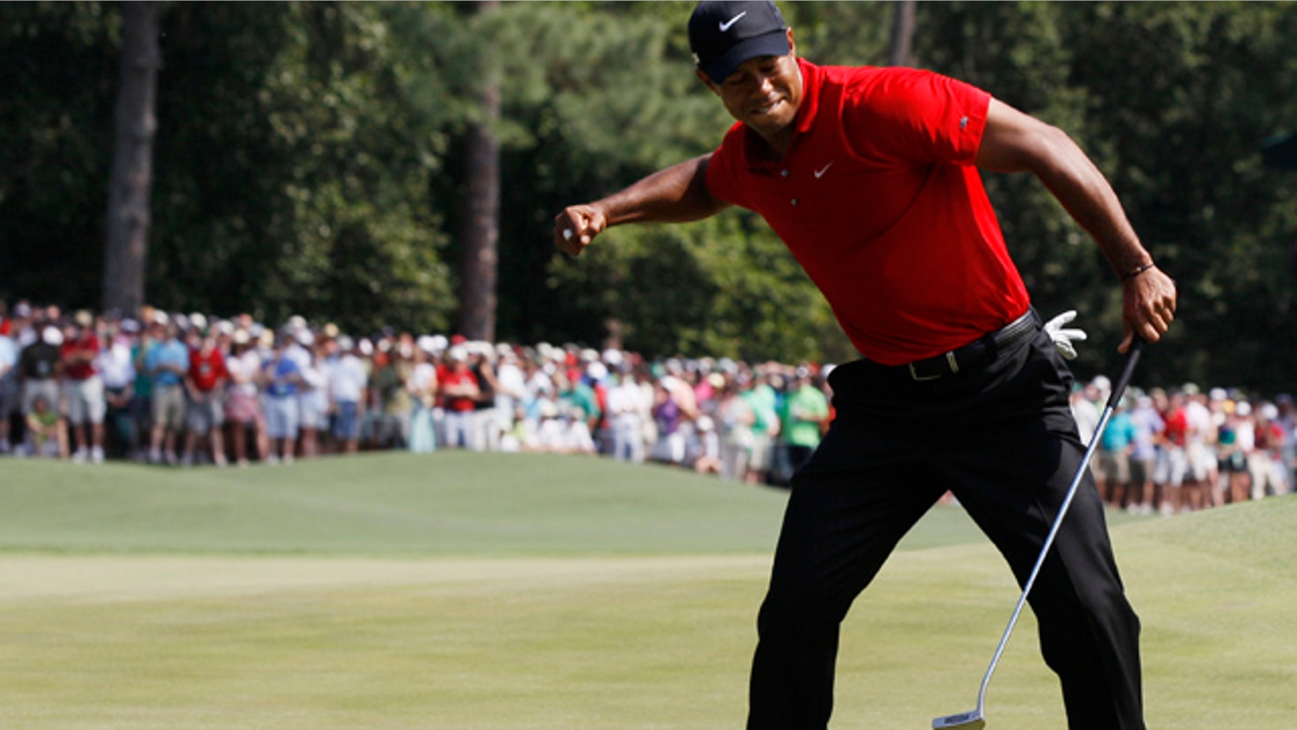 April 10, 2011: Tiger Woods reacts after an eagle putt on the eighth hole during the final round of the Masters golf tournament.
