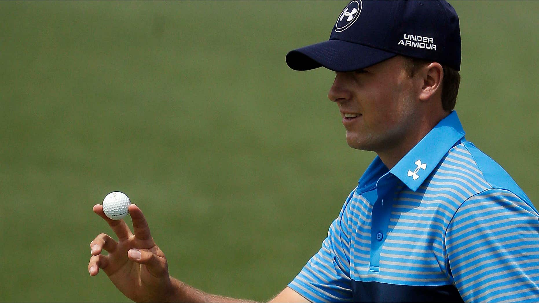 April 9, 2015: Jordan Spieth holds up his ball a birdie on the second hole during the first round of the Masters golf tournament.