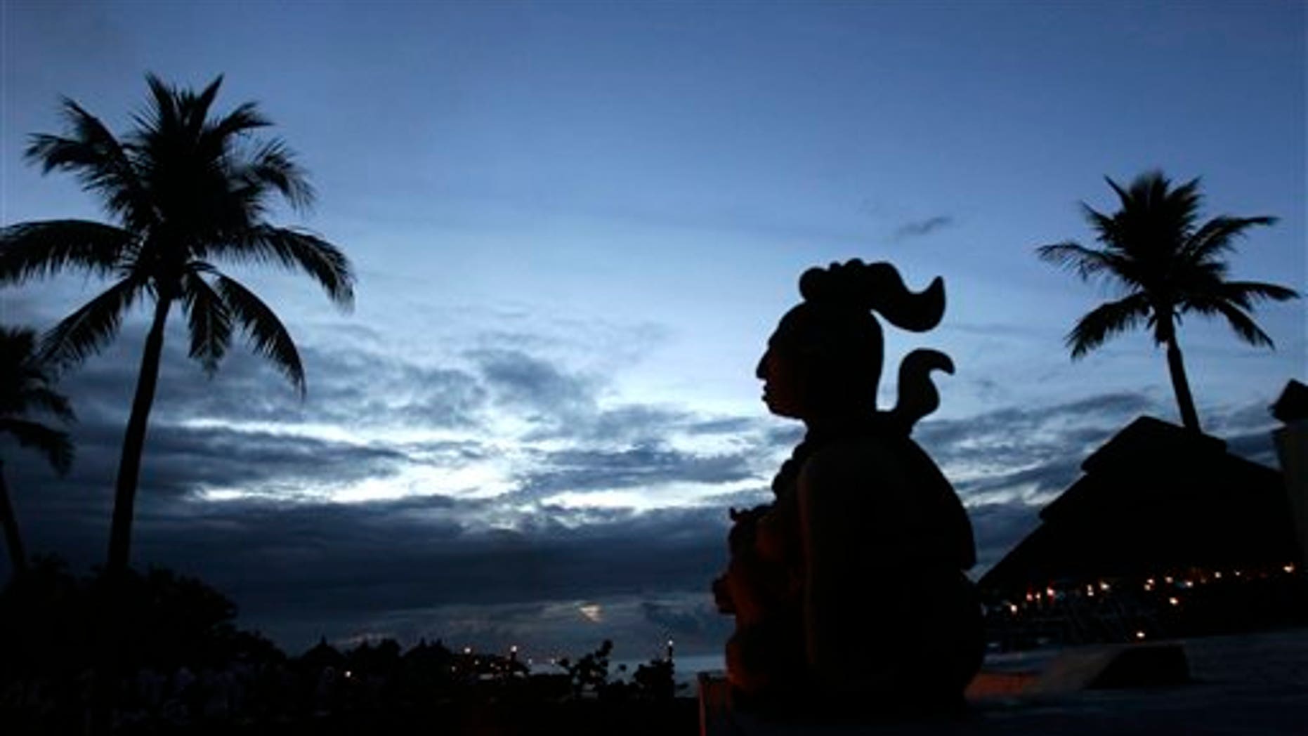 FILE - This June 1, 2007 file photo shows a Mayan statue stands in Playa Del Carmen, Mexico, where people will gather before making their way across the Yucatan Channel, to the Cozumel Island, in a ten mile pilgrimage in honor of the Mayan goddess Ixchel. Only a year is left before Dec. 21, 2012, when some believe the Maya predicted the end of the world. While some doomsday theorists may suggest putting together survival kits, people in southeastern Mexico, the heart of Maya territory, plan to throw a yearlong celebration. And to make a profit while they party.(AP Photo/Israel Leal)