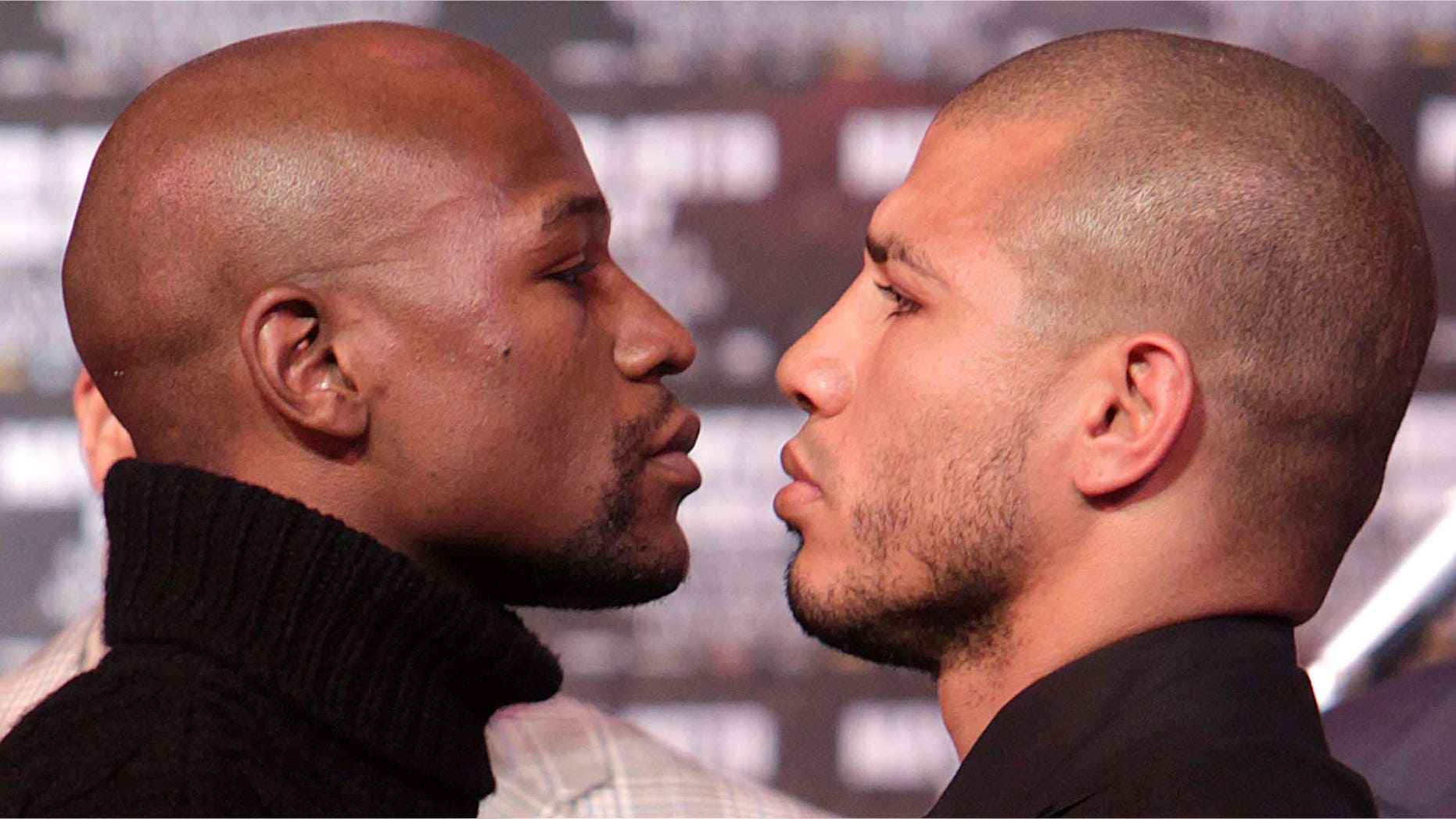 Boxers Floyd Mayweather, left, and Miguel Cotto face-off during a news conference in New York, Tuesday, Feb. 28, 2012.
