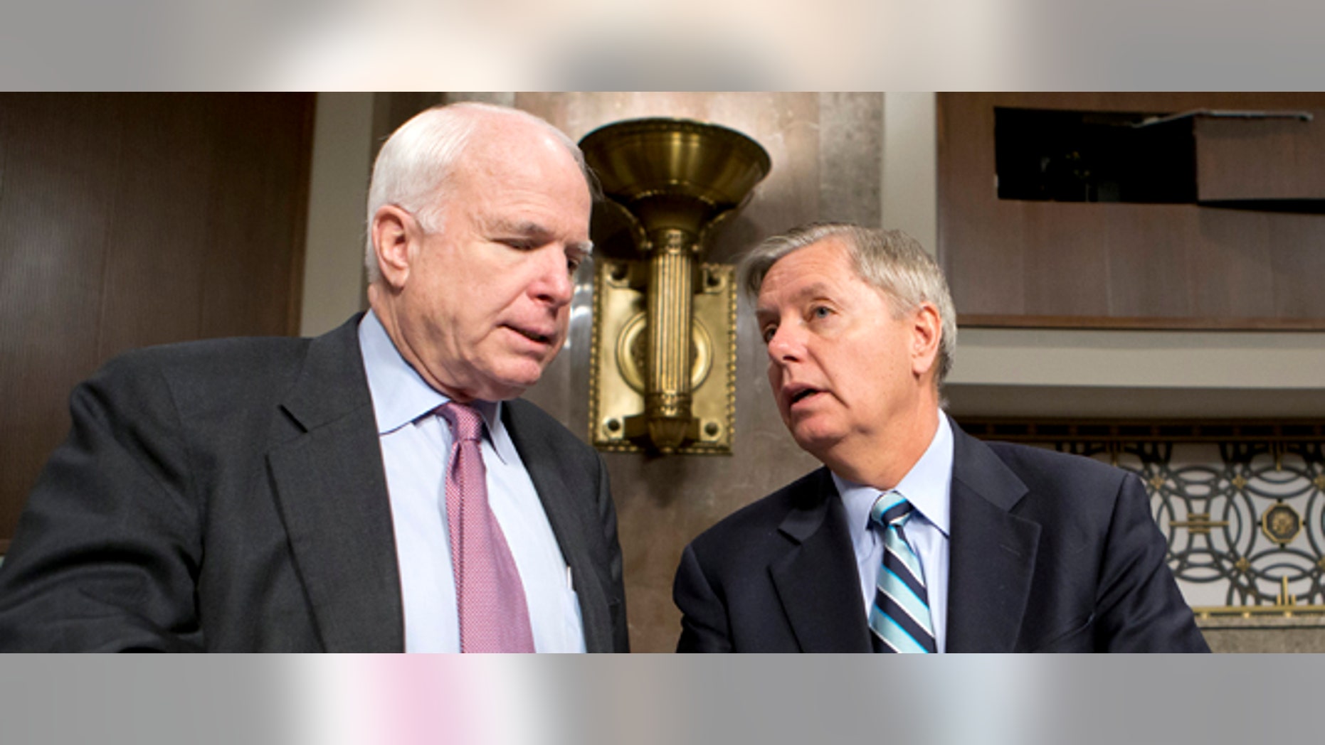 FILE - In this Feb. 14, 2013 file photo, Sen. John McCain, R-Ariz., left, and Sen. Lindsey Graham, R-S.C. confer on Capitol Hill in Washington. McCain, Sen. Lindsey Graham, R-S.C., Sen. and Jeff Flake, R-Ariz. met with key House conservatives this week to promote legislation to overhaul the nation's immigration laws and provide a pathway to citizenship for an estimated 11 million illegal immigrants, McCainâs communications director said Friday. (AP Photo/J. Scott Applewhite, File)
