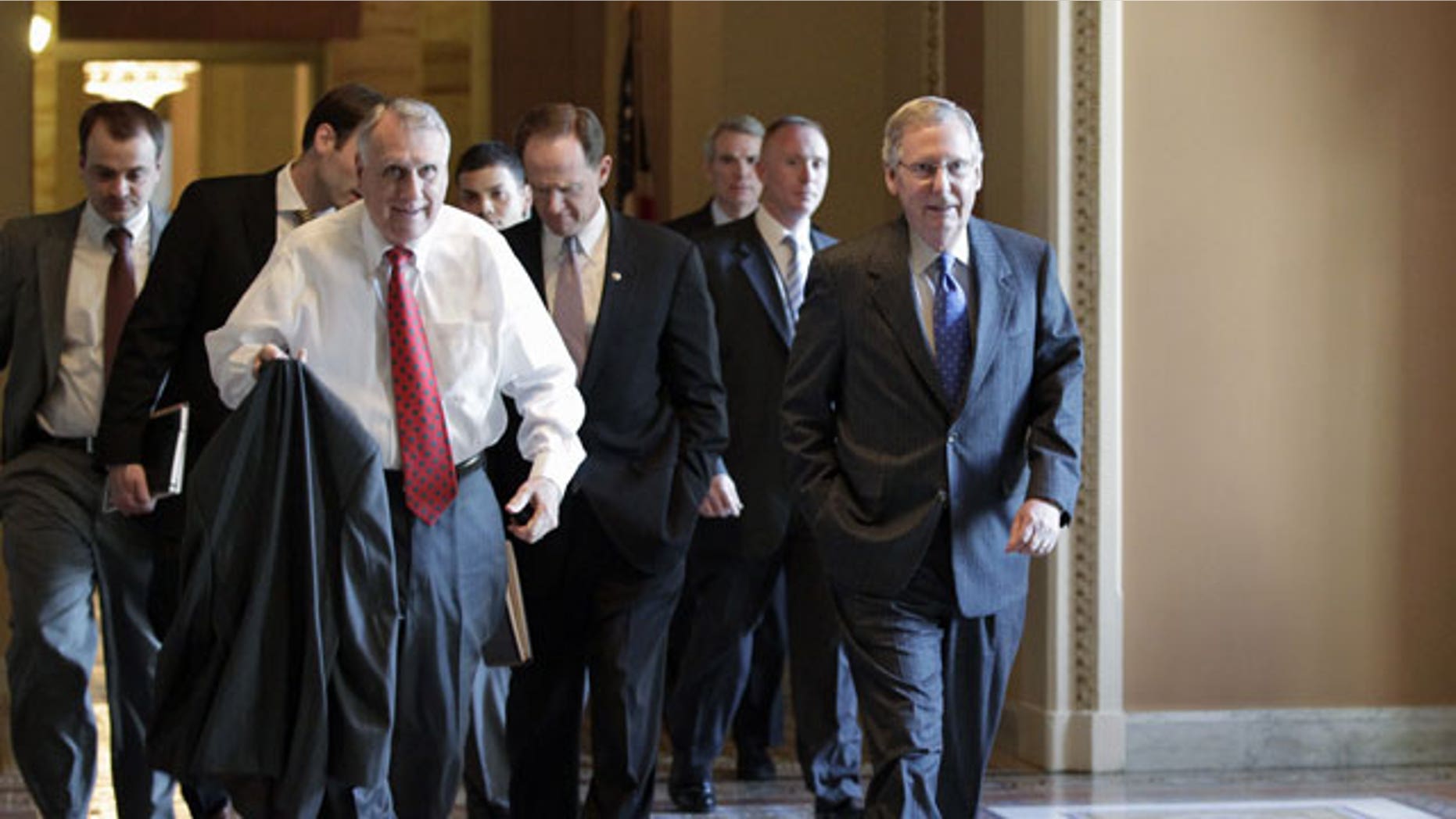 November 3, 2011: Senate Minority Leader Mitch McConnell of Ky., right, walks to the floor of the Senate with Senate Minority Whip Jon Kyl of Ariz., left, Sen. Patrick Toomey, R-Pa., center, and others, on Capitol Hill in Washington.