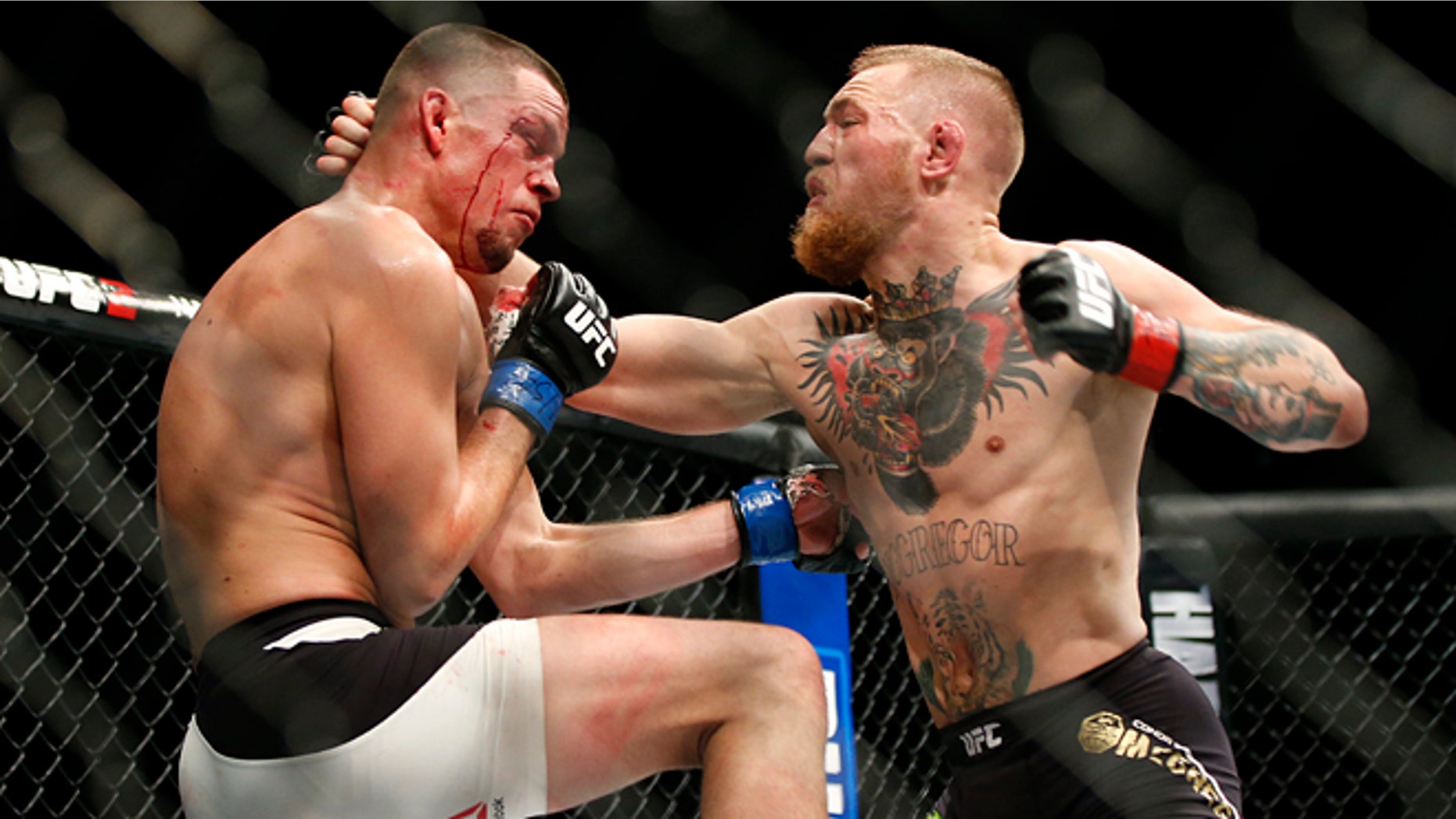 FILE - In this Saturday, March 5, 2016 file photo, Conor McGregor, right, trades punches with Nate Diaz during their UFC 196 welterweight mixed martial arts match in Las Vegas. Conor McGregor has packed a punch on social media rather than inside a UFC cage. One of the UFCs top draws, McGregor created a stir Tuesday, April 19, 2016 when he tweeted that retirement was on the horizon. (AP Photo/Eric Jamison, File)