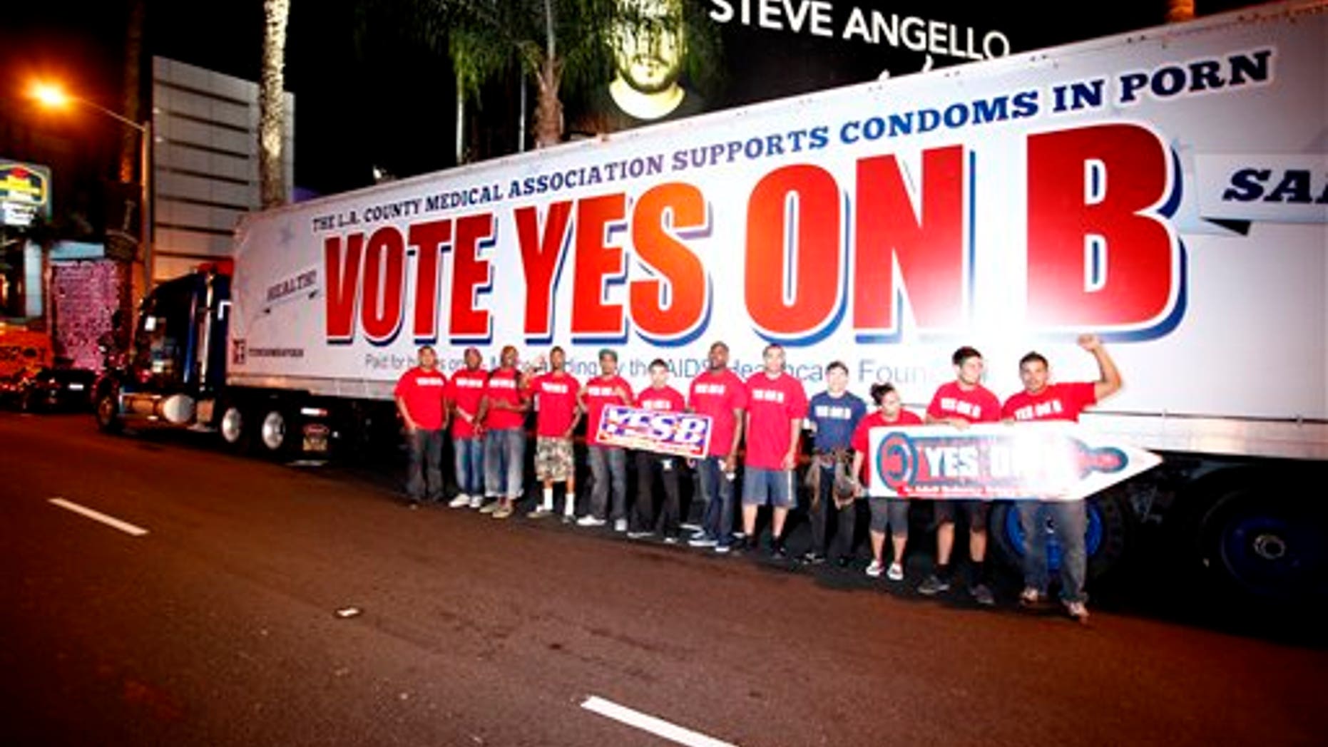 IMAGE DISTRIBUTED FOR AIDS Healthcare Foundation - Supporters of Vote Yes on B in Los Angeles, the condoms in porn measure on the November ballot led by AIDS Healthcare Foundation, hand out voter information and free condoms on L.A's famed Sunset Strip on Saturday, Oct. 27, 2012, in Los Angeles, Calif. After an all day caravan to five cities throughout Los Angeles. The 'Yes on B' caravan covered 137 miles through Hollywood, Long Beach, Northridge, Canoga Park and West Hollywood handing out 150,000 condoms with only ten days before election day. (Photo by Joe Kohen/AP Images for AIDS Healthcare Foundation)