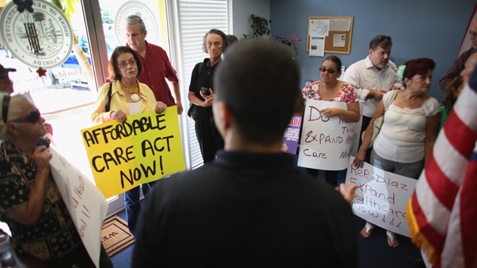 Daniel Martinez, an aide to Florida State Rep. Manny Diaz, speaks to protesters on September 20, 2013 in Miami, Florida.