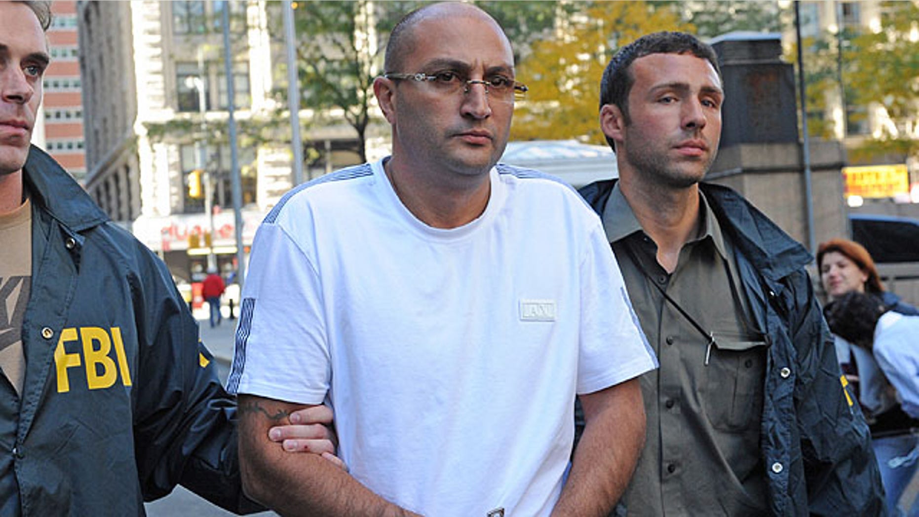 Oct, 13, 2010: Robert Terdjanian is led in handcuffs from FBI headquarters in New York. Dozens of people on both coasts have been charged by Manhattan prosecutors in a $100 million Medicare fraud scheme.