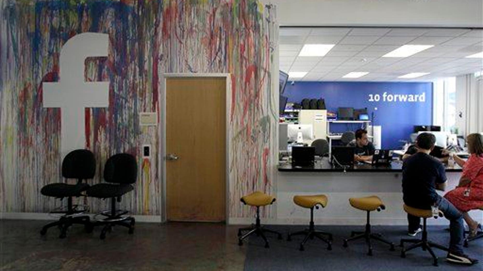 This May 11, 2012, photo shows workers at the Facebook office in Menlo Park, Calif.