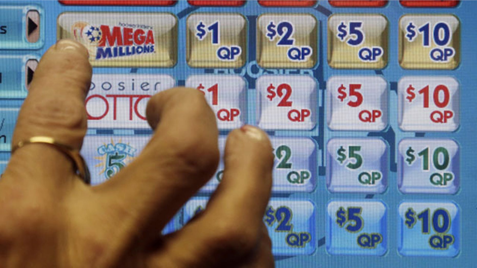 December 17, 2013: A clerk prepares to operate a lottery machine to print out Mega Millions lottery tickets for a customer in Muncie, Ind. The March 18, 2014 estimated $400 million Mega Millions jackpot could potentially be the sixth-largest in lottery prize in U.S. history. (AP Photo/Darron Cummings, File)