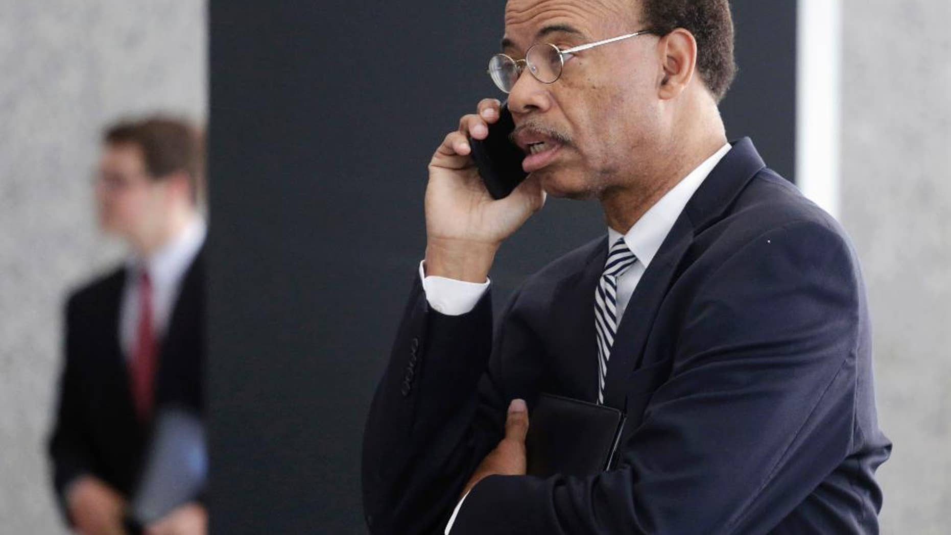 Former Illinois Congressman Mel Reynolds talks on his cell phone as he leaves federal court in Chicago, Thursday, July 30, 2015, after pleading not guilty to federal tax charges. Reynolds, with no home of his own, is scrambling to find a place to stay after prosecutors told the hearing that restrictions on sexual offenders should apply to the Chicago Democrat. Reynold's resigned from Congress in 1995 after being convicted of statutory rape. The housing issues arose when the hearing moved to questions about bond. (AP Photo/M. Spencer Green)