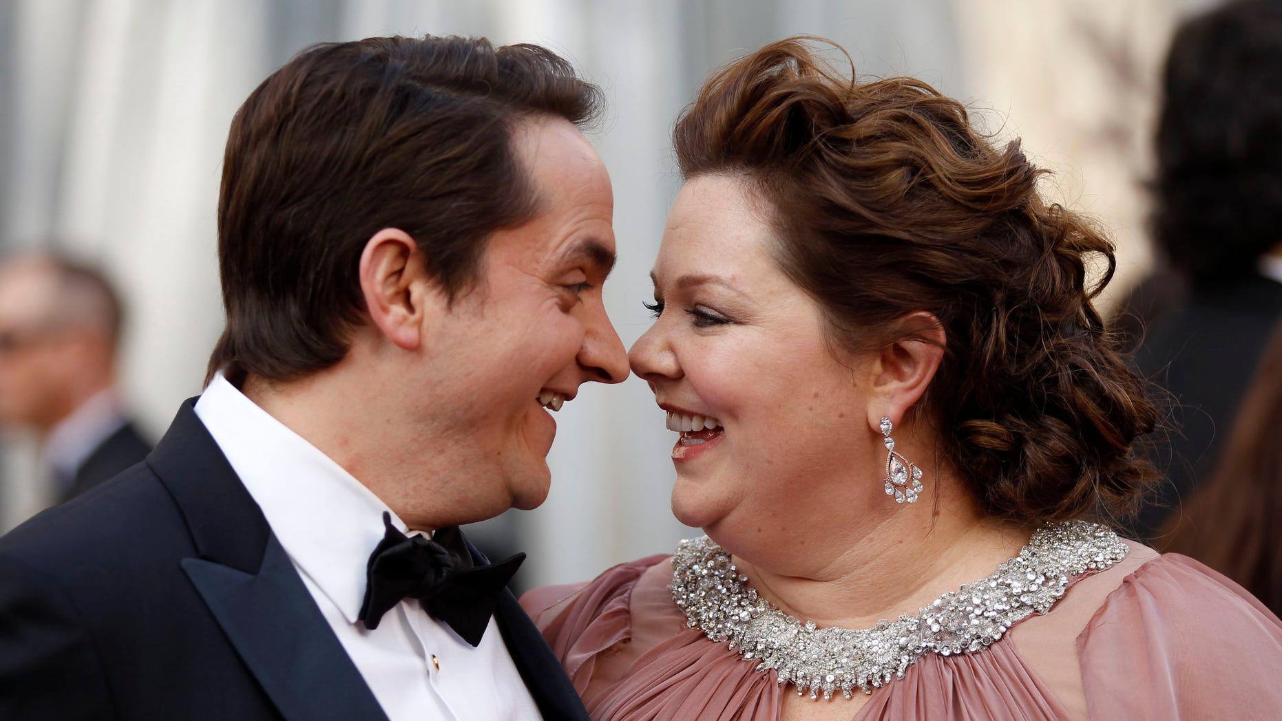 Melissa McCarthy, best supporting actress nominee for her role in "Bridesmaids," and her husband, Ben Falcone, arrive at the 84th Academy Awards in Hollywood, California, February 26, 2012. REUTERS/Lucy Nicholson (UNITED STATES) (OSCARS-ARRIVALS)
