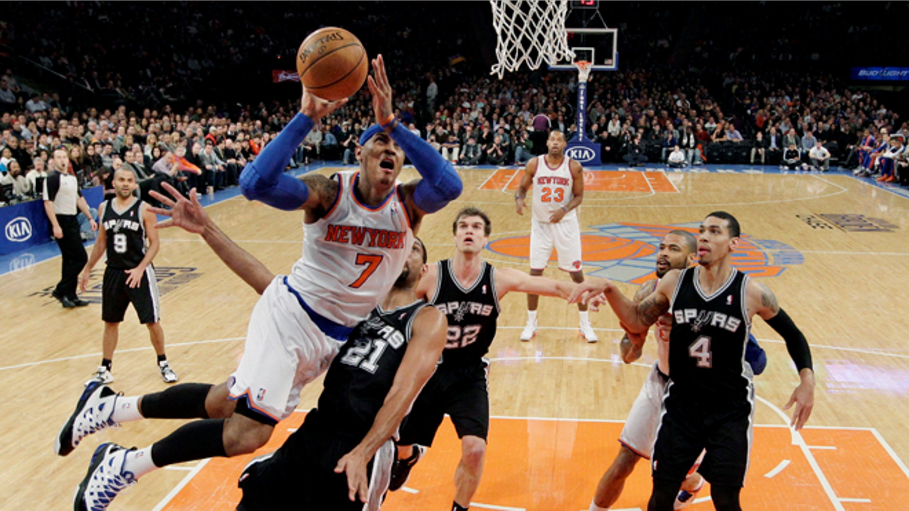 New York Knicks forward Carmelo Anthony (7) shoots a layup against San Antonio Spurs forward Tim Duncan (21) as guard Tony Parker (9), forward Tiago Splitter (22) and guard Danny Green (4) watch in the first half of their NBA basketball game at Madison Square Garden in New York, Thursday, Jan. 3, 2013. Anthony scored 23 points as the Knicks won 100-83. (AP Photo/Kathy Willens)