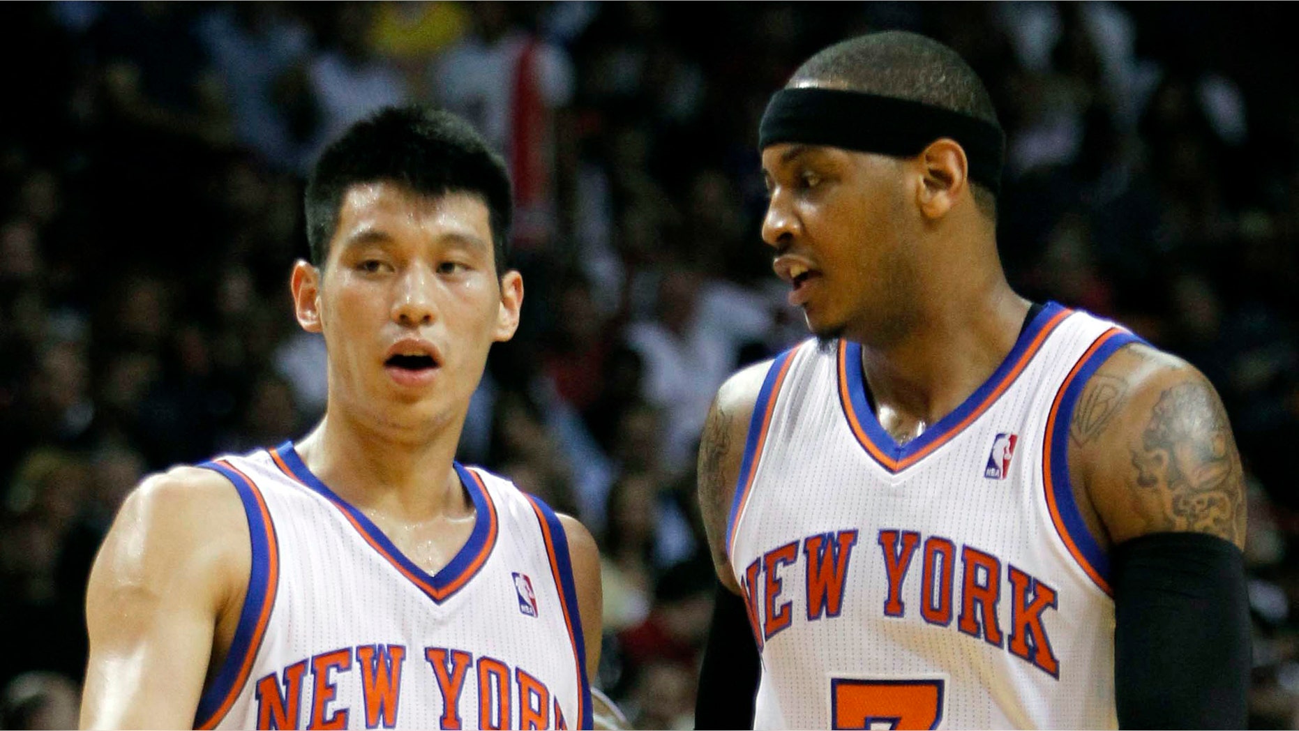 New York Knicks guard Jeremy Lin (17) and teammate Carmelo Anthony (7) talk during the first half of an NBA basketball game against the Miami Heat, Thursday, Feb. 23, 2012, in Miami. (AP Photo/Alan Diaz)