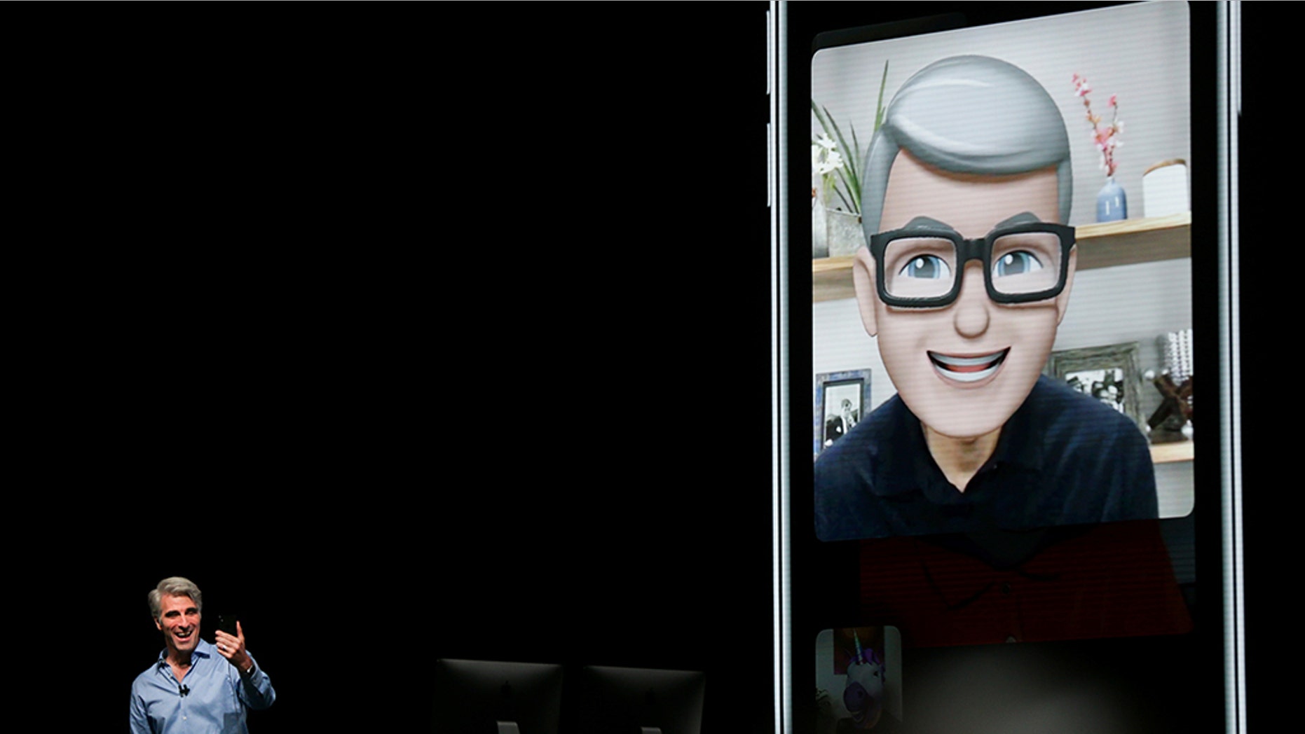 Apple senior vice president of Software Engineering Craig Federighi speaks with Apple CEO Tim Cook using the new group Facetime feature at the Apple Worldwide Developer conference (WWDC) in San Jose, California, U.S., June 4, 2018. REUTERS/Elijah Nouvelage - RC1A8138D8E0