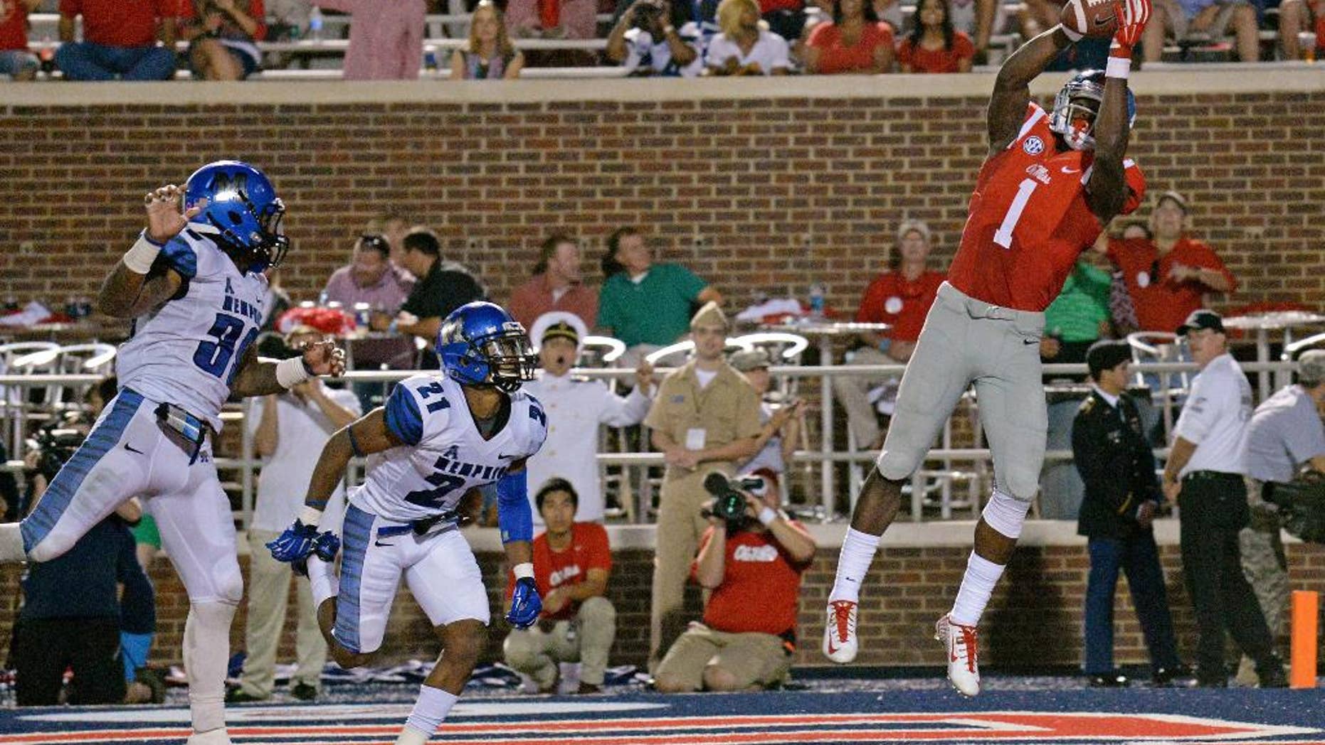 Mississippi wide receiver Laquon Treadwell (1) catches a touchdown pass as Memphis defensive backs Reggis Ball (39) and Bobby McCain (21) watch during the second half of an NCAA college football game in Oxford, Miss., Saturday, Sept. 27, 2014. No. 10 Mississippi won 24-3. (AP Photo/The Daily Mississippian, Thomas Graning)