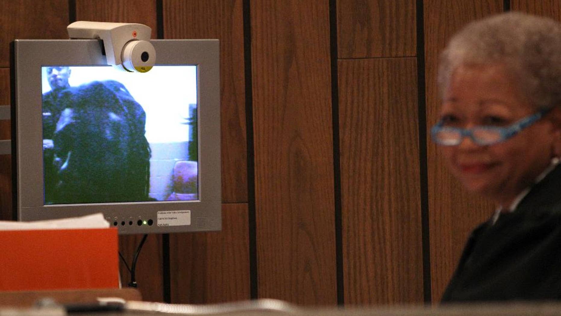Defendant Tremaine Wilbourn appears before Judge Loyce Lambert Ryan via video arraignment Wednesday, Aug. 5, 2015, in general session court Division 15 on charges of first degree murder for the death of Memphis police Officer Sean Bolton. Wilbourn did not enter a plea on the charge of first-degree murder. (Mike Brown/The Commercial Appeal via AP)