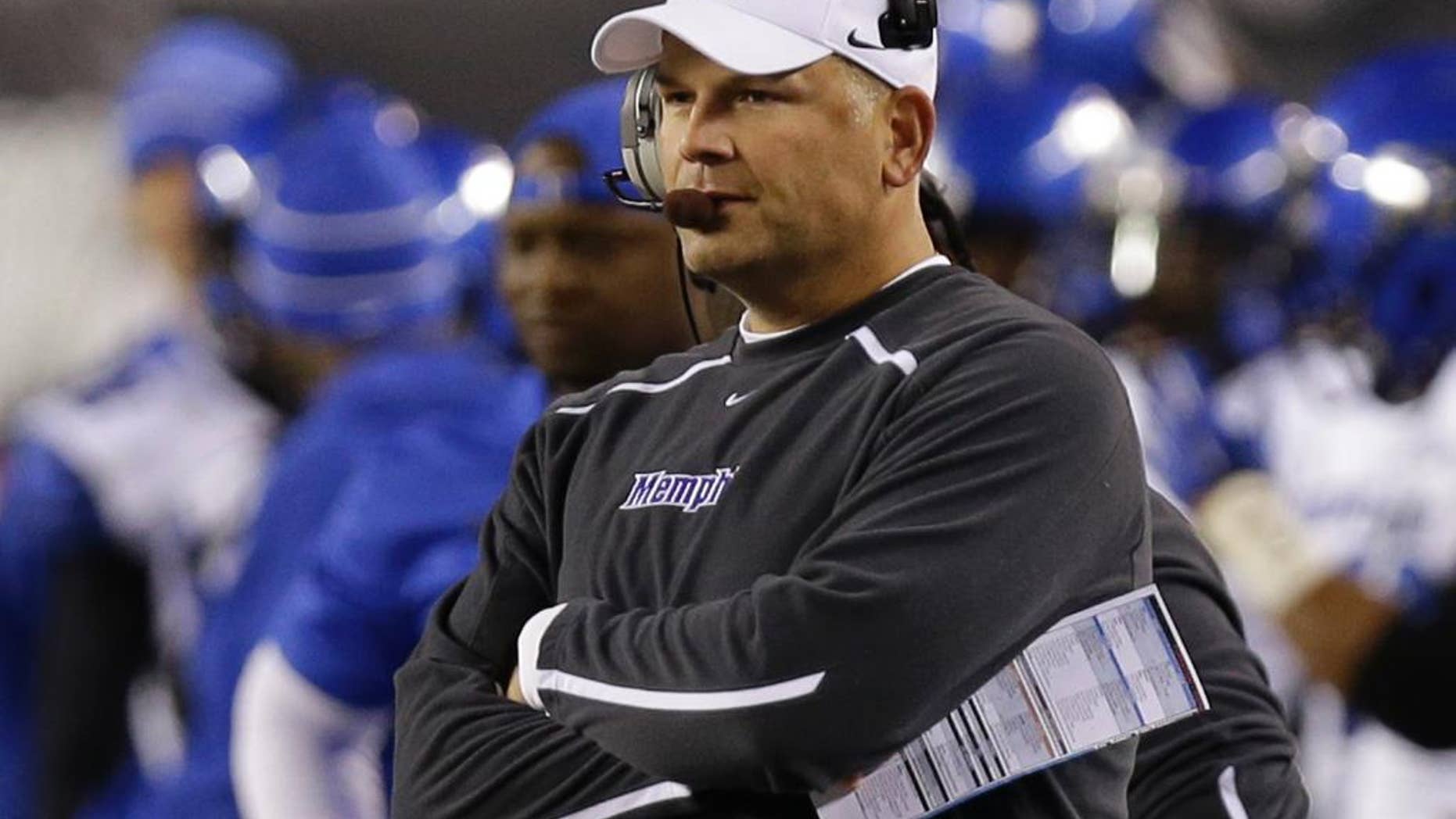 FILE -- In this Oct. 4, 2014, file photo, Memphis coach Justin Fuente watches from the sideline in the first half of an NCAA college football game against Cincinnati in Cincinnati. Fuente said he saw plenty of potential in Memphis when he was hired to take over the program in December 2011. Now, his faith is being rewarded as Memphis could clinch at least a share of the American Athletic Conference title with a victory Saturday against Connecticut. (AP Photo/Al Behrman, File)