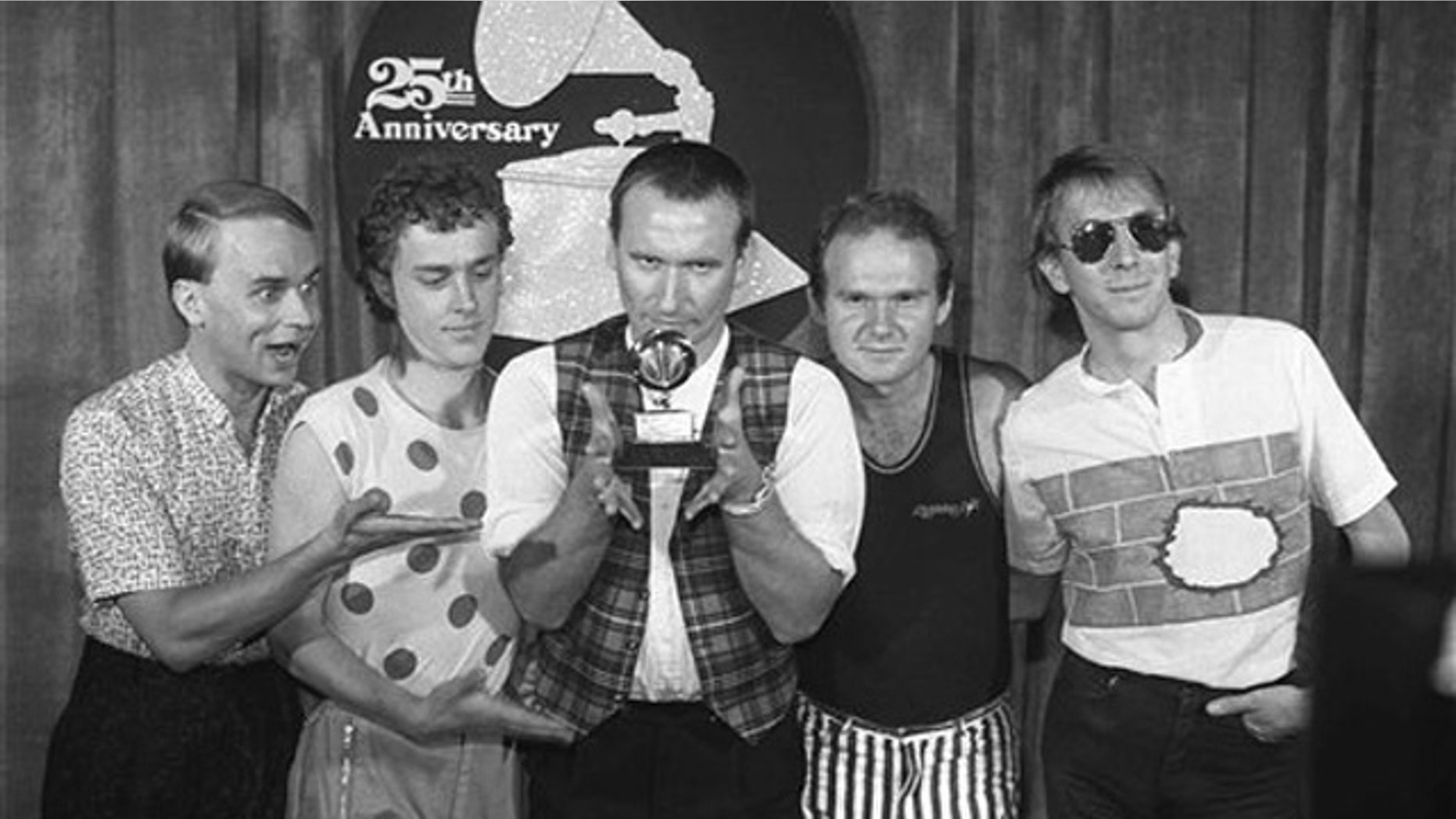 Feb. 22, 1983: In this file photo, members of 'Men at Work' from left, Greg Ham, Ron Strykert, Colin Hay, Jerry Speiser and John Rees, pose with their Grammy for best new artist at the awards show in Los Angeles.