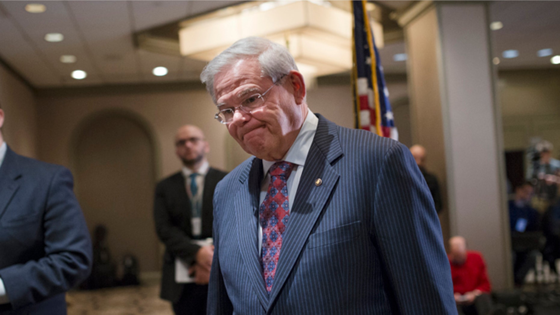 Sen. Bob Menendez, D-N.J., leaves after news conference in Newark, N.J. on Friday, March 6, 2015. A person familiar with a federal investigation says the Justice Department is expected to bring criminal charges against the New Jersey Democrat in the coming weeks. Menendez says that he has always behaved appropriately in office. (AP Photo/John Minchillo)