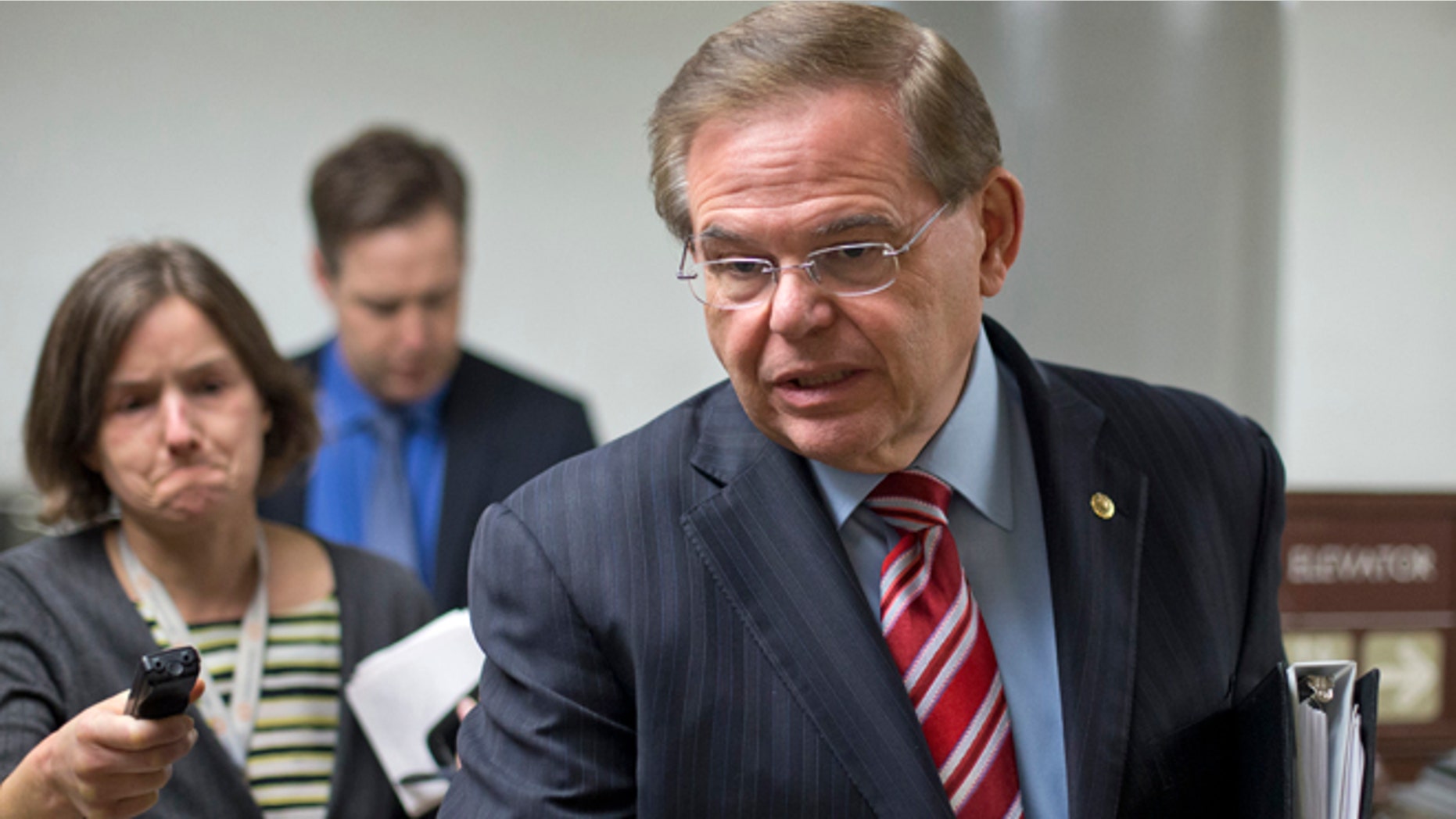 Sen. Bob Menendez, D-N.J., rushes through the Capitol on the way to the Senate Foreign Relations Committee, where he is taking over as chairman, replacing John Kerry, the new secretary of state, Wednesday, Feb. 13, 2013, on Capitol hill in Washington. (AP Photo/J. Scott Applewhite)