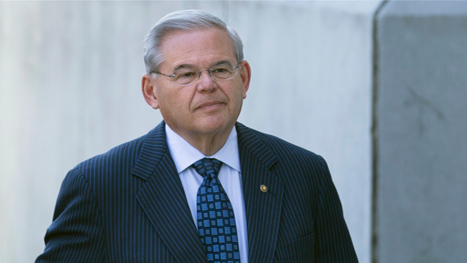 U.S. Sen. Bob Menendez arrives at Newark federal court, Thursday, April 2, 2015, in Newark, N.J. Menendez, the top Democrat on the U.S. Senate Foreign Relations Committee, was indicted Wednesday on corruption charges. A federal grand jury indictment accuses Menendez of using the power of his Senate seat to benefit Salomon Melgen, a wealthy Florida eye doctor who prosecutors say provided the senator with luxury vacations, airline travel, golf trips and tens of thousands of dollars in contributions to a legal defense fund. (AP Photo/John Minchillo)