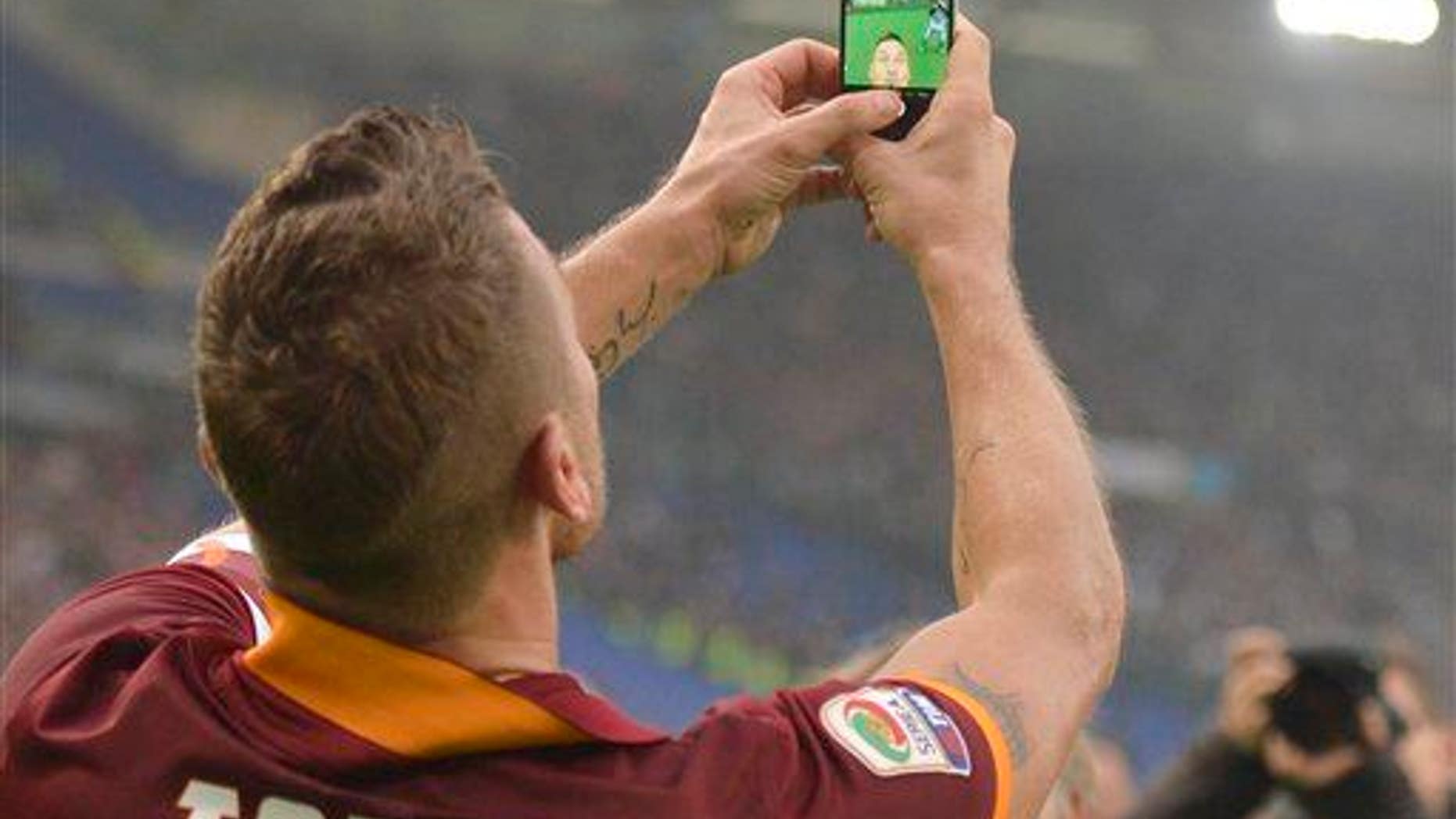 Roma's Francesco Totti takes a selfie after scoring during a Serie A soccer match between Roma and Lazio.