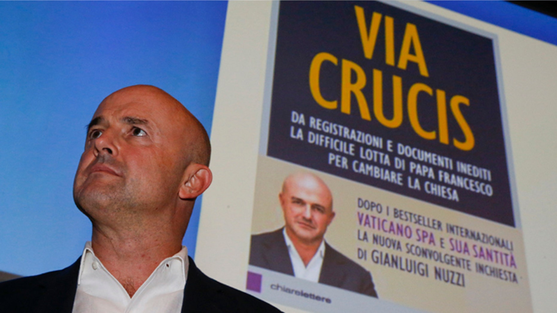 Italian journalist and writer Gianluigi Nuzzi attends a press conference to promote the release of his new book ''Via Crucis'' ("Merchants in the Temple", in the English language edition) in Milan, Italy, Monday, Nov. 16 2015. In his book Nuzzi makes some startling allegations, including a report that Vatican "postulators" - officials who promote sainthood causes - bring in hundreds of thousands of euros in donations for their causes but are subject to no oversight as to how the money is spent. (AP Photo/Luca Bruno)