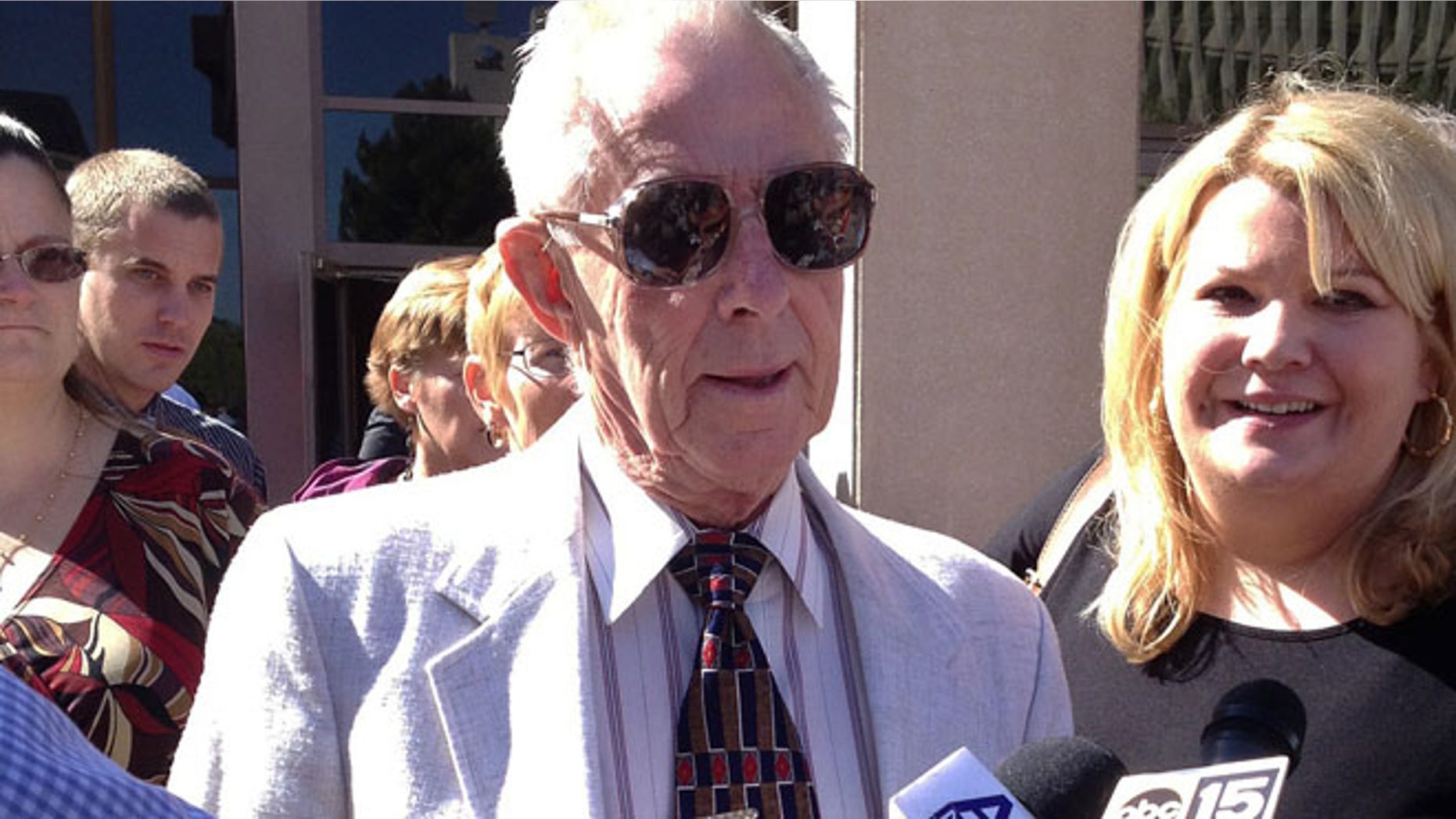 March 29: George Sanders, center, is joined by his attorney Janey Henze Cook, right, outside a Phoenix courtroom.