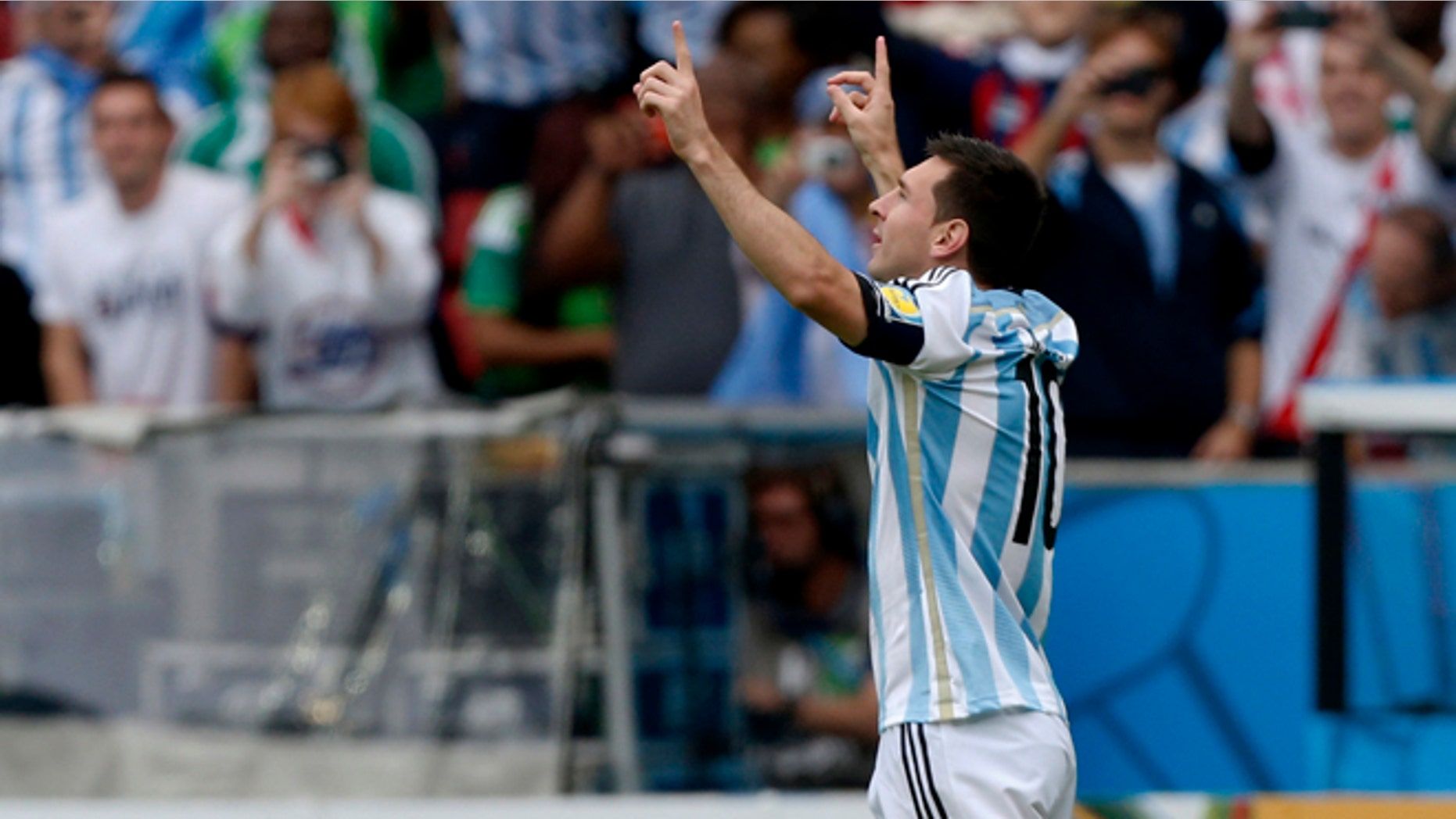 Argentina's Lionel Messi celebrates after scoring his side's first goal during the group F World Cup soccer match against Nigeria at the Estadio Beira-Rio in Porto Alegre, Brazil, Wednesday, June 25, 2014. (AP Photo/Martin Meissner)(AP Photo/Jon Super)