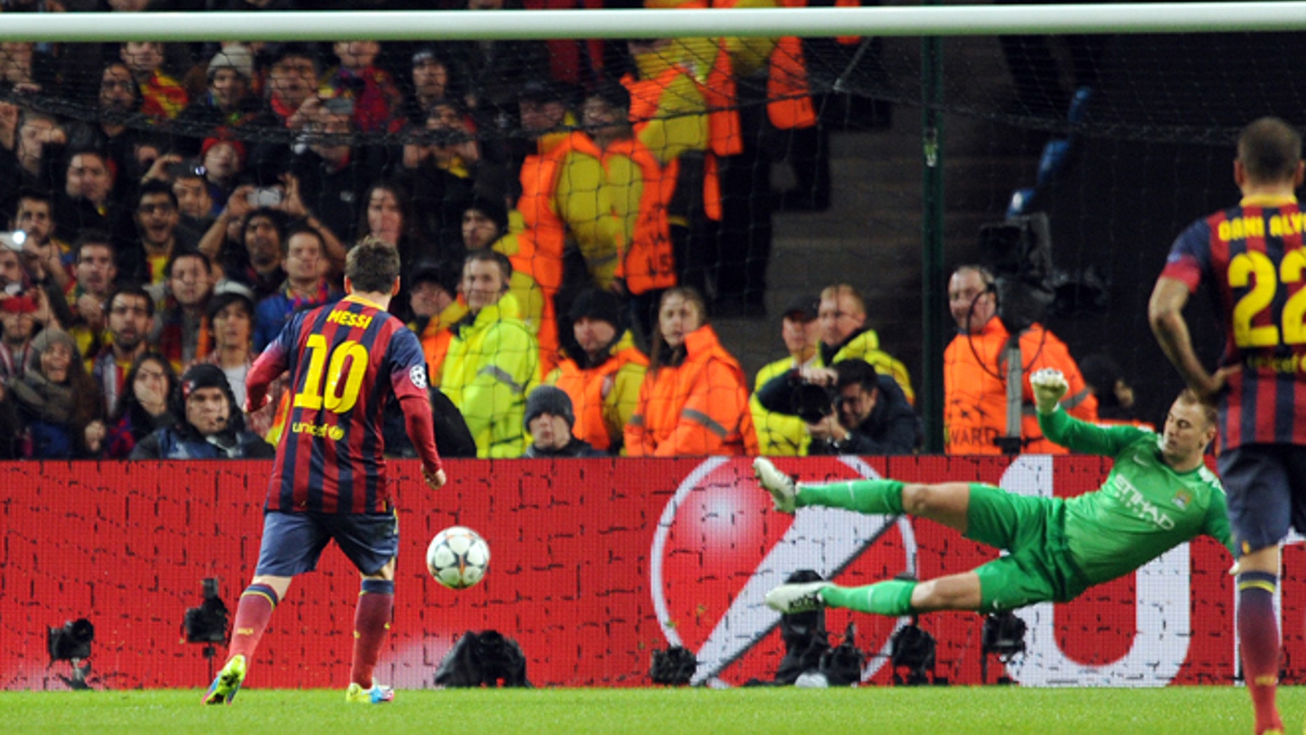 Barcelona's Lionel Messi, left, scores the first goal of the game for his side from a penalty during their Champions League Round of 16 soccer match against Manchester City at the Etihad Stadium in Manchester, England, Tuesday, Feb. 18, 2014. (AP Photo/Clint Hughes)