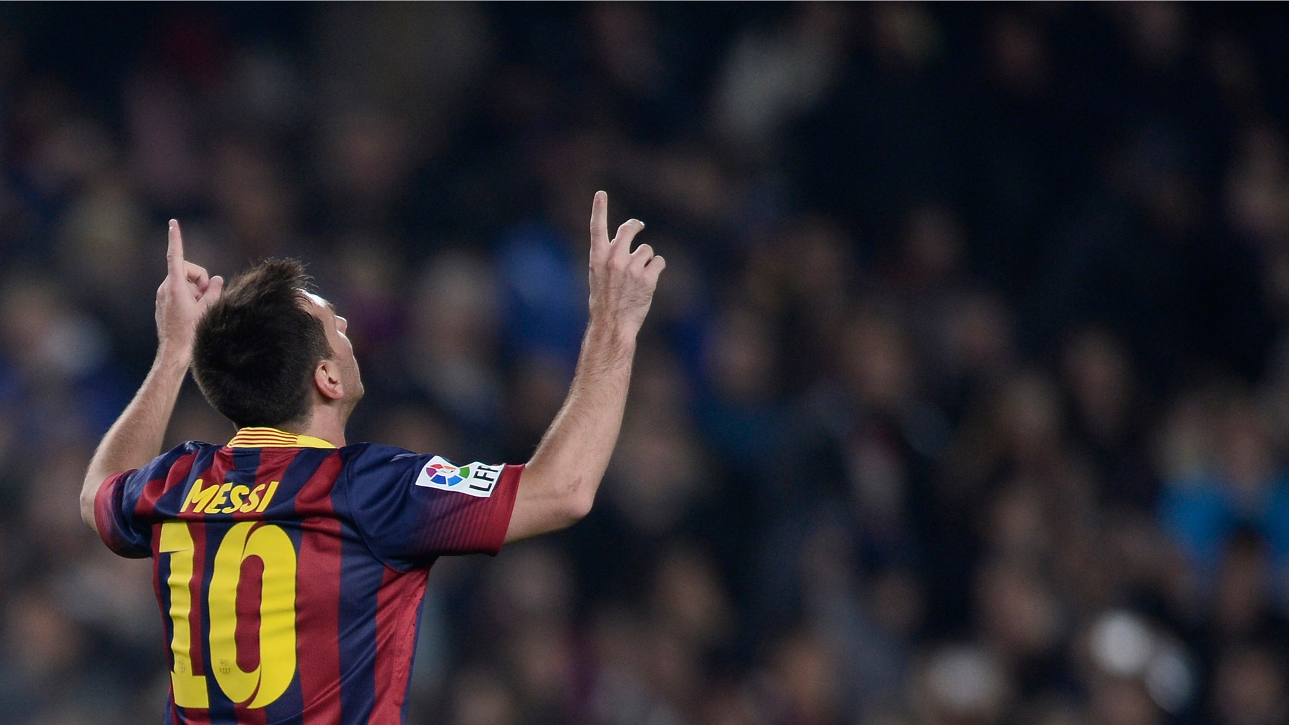 FC Barcelona's Lionel Messi, from Argentina, reacts after scoring against Getafe during a Copa del Rey soccer match at the Camp Nou stadium in Barcelona, Spain, Wednesday, Jan. 8, 2014. (AP Photo/Manu Fernandez)