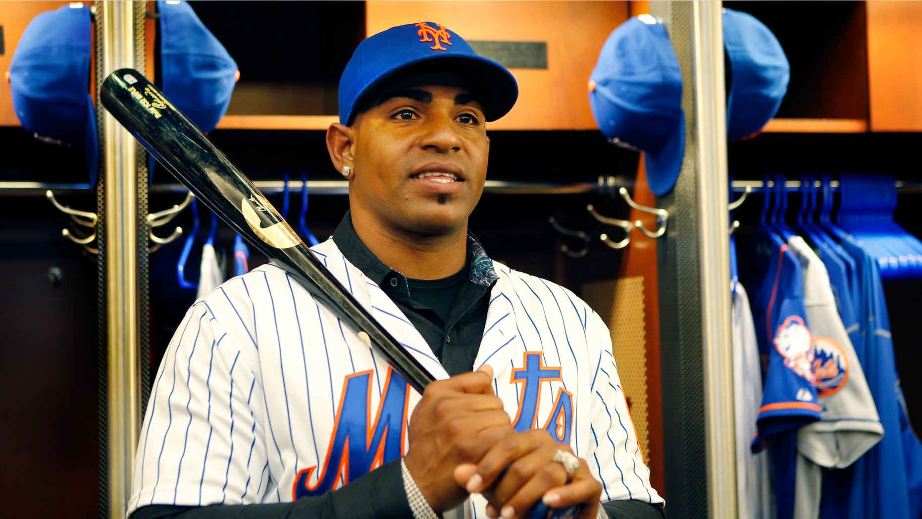 New York Mets Yoenis Cespedes holds a bat as he poses in the clubhouse after a baseball press conference at CitiField in New York, Wednesday, Feb. 3, 2016. Cespedes agreed to a $75 million, three-year deal with the team. (AP Photo/Kathy Willens)