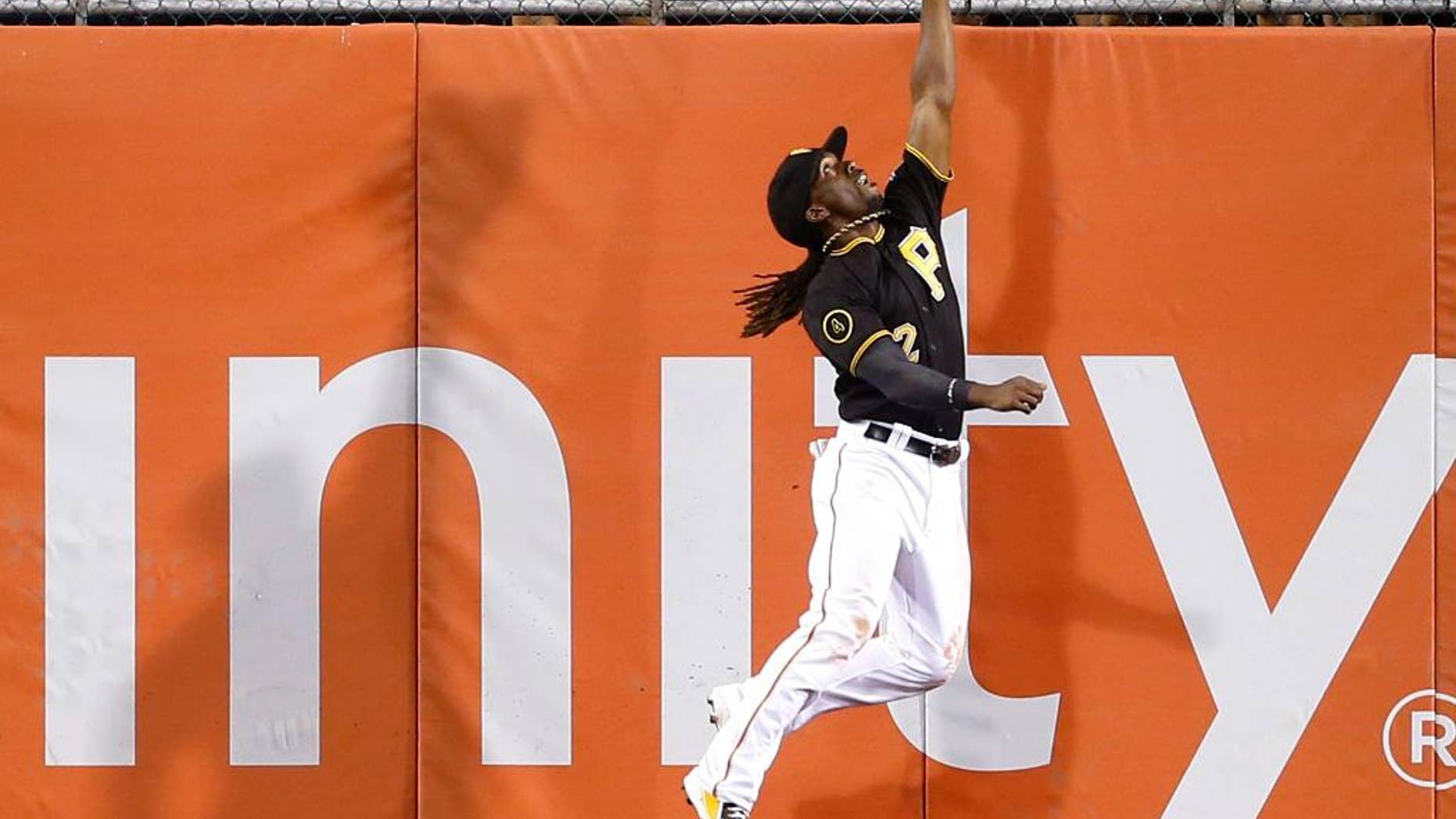 Pittsburgh Pirates center fielder Andrew McCutchen (22) leaps next to the wall to catch a deep fly ball by New York Mets' Curtis Granderson in the eighth inning of a baseball game Friday, June 27, 2014, in Pittsburgh. The Pirates won -3-2 in 11 innings. (AP Photo/Keith Srakocic)