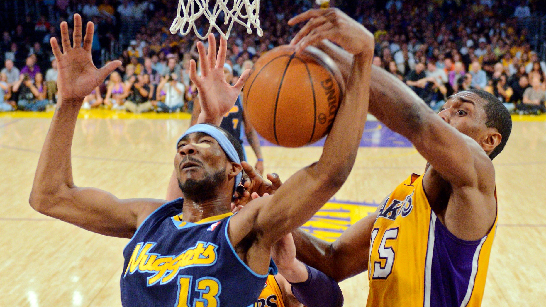 Denver Nuggets forward Corey Brewer, left, and Los Angeles Lakers forward Metta World Peace grapple for the ball during the first half of Game 7 in their first-round NBA basketball playoff series, Saturday, May 12, 2012, in Los Angeles. (AP Photo/Mark J. Terrill)