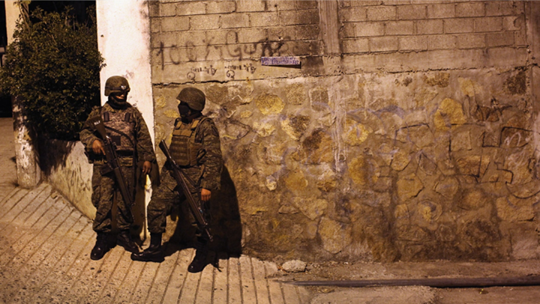 ACAPULCO, MEXICO - MARCH 03: Mexican army soldiers stand guard near a suspected drug-related murder site March 3, 2012 in Acapulco, Mexico. A forensics team excavated five corpses from the floor of an abandoned house. Officials said the five victims were apparently buried alive in concrete. Drug violence has surged in the coastal resort in the last year, making Acapulco the second most deadly city in Mexico after Juarez. One of Mexico's top tourist destinations, Acapulco has suffered a drop in business, especially from foreign tourists, due to the violence. Toursim accounts for about 70 percent of the economy of Acapulco's state of Guerrero and 9 percent of Mexico's economy. (Photo by John Moore/Getty Images)