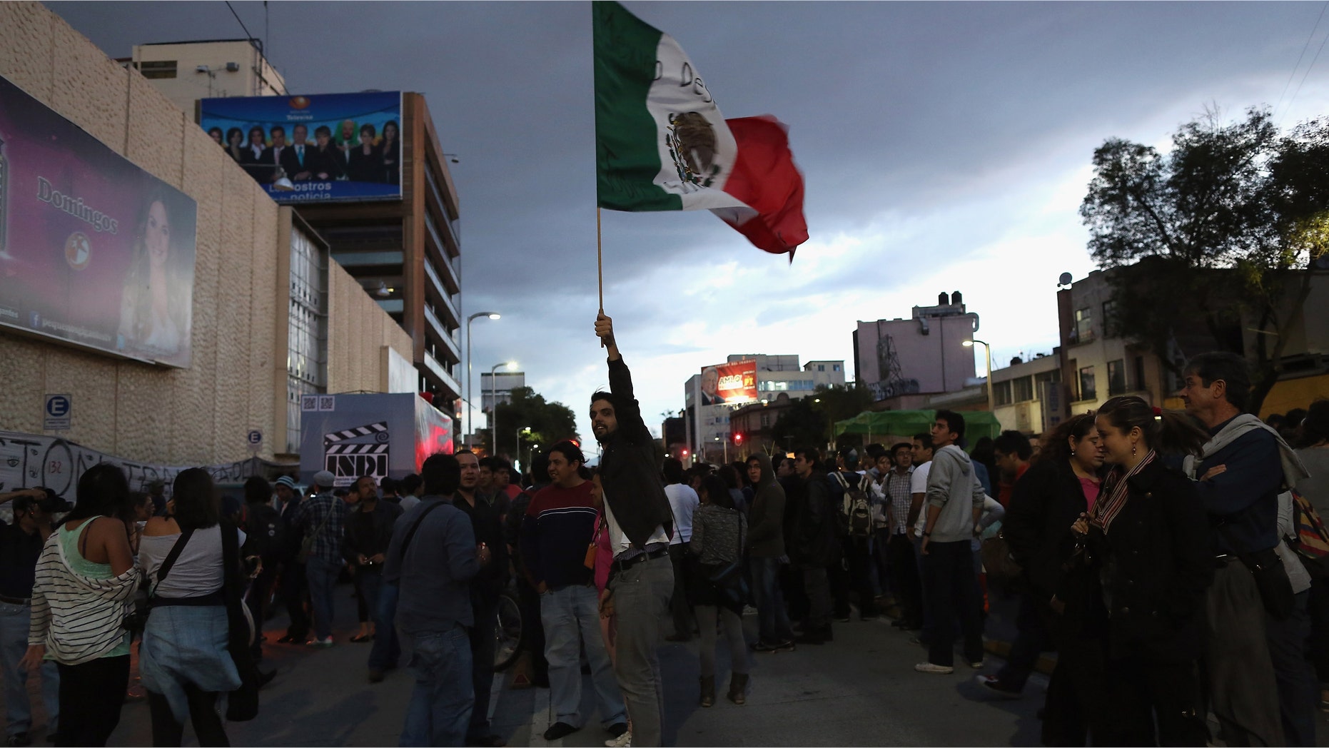 MEXICO CITY, MEXICO - JUNE 26: Student protesters stage a demonstration calling for electoral transparency in front of Mexico's Televisa network headquarters on June 26, 2012 in Mexico City, Mexico. A popular university student movement known as YoSoy132 has been staging protests calling for a transparent democratic process in Sunday's upcoming presidential election. The movement began as opposition to the Institutional Revolutionary Party (PRI) presidential candidate Enrique Pena Nieto and the Mexican media's allegedly biased campaign coverage in favor of the PRI. (Photo by John Moore/Getty Images)