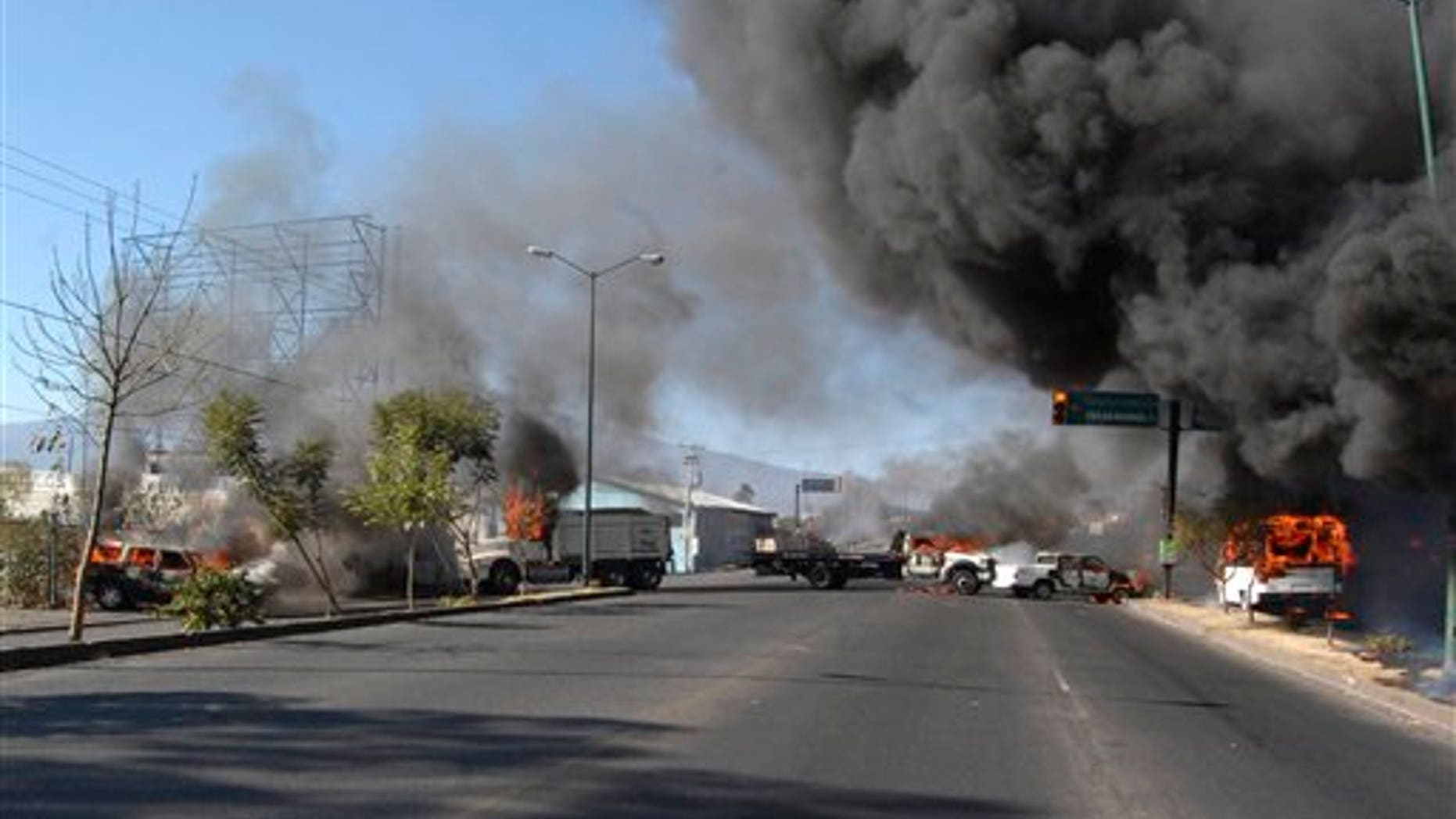 Dec. 9, 2010: Vehicles burn on a road leading to the city of Morelia, Mexico, after gunmen arrived at all five roads leading into the city, fired into the air and forced people from their vehicles.