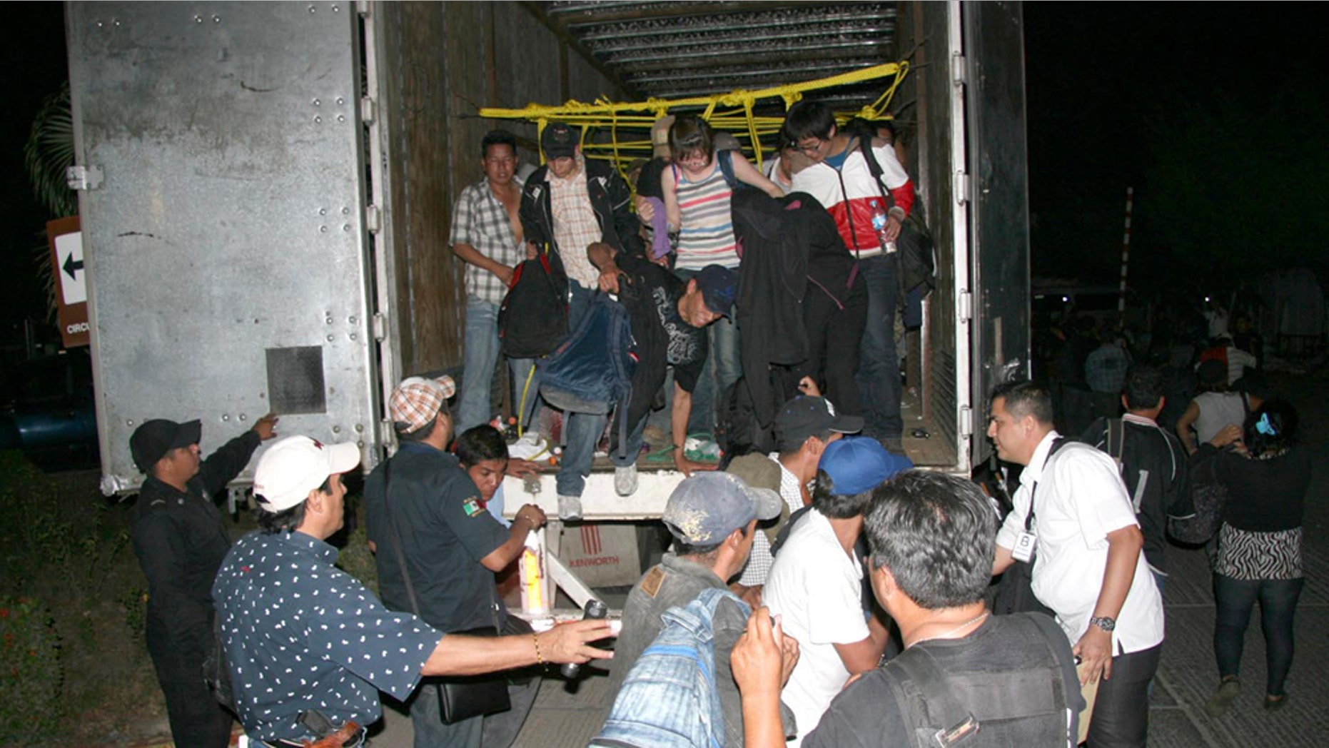 In this photo released by Chiapas State Attorney General, migrants from Latin America and Asia leave a truck that was heading to the US after being detected by an X-ray equipment at a checkpoint near Tuxtla Gutierrez, in Mexico's southern Chiapas state, Tuesday, May 17, 2011. Police in Mexico's southern Chiapas state found over 500 migrants Tuesday inside two trailer trucks. (AP Photo/Chiapas State Attorney General)