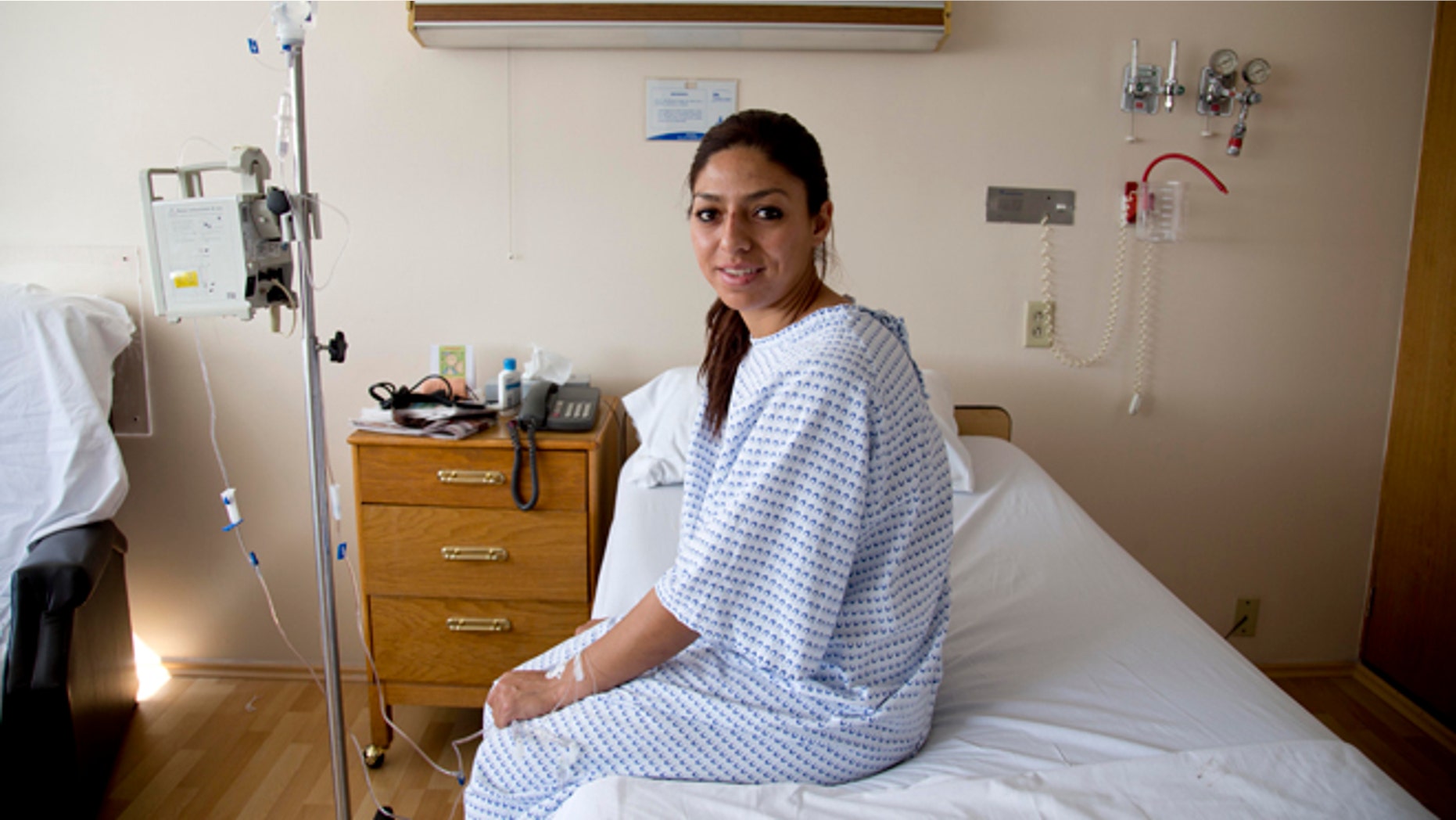 Karla Sanchez San Martin, one of Mexico's few female bullfighters, poses for a portrait in her hospital bed in Mexico City, Tuesday, Dec. 30, 2014. Sanchez, who goes by the name Karla de los Angeles as a bullfighter, suffered a pair of gashes to the thigh and buttock when she was gored twice by a bull on Sunday but says she's determined to return to the ring by mid-January, two days after she and several others were gored by what she described as a "very smart" bull. (AP Photo/Eduardo Verdugo)